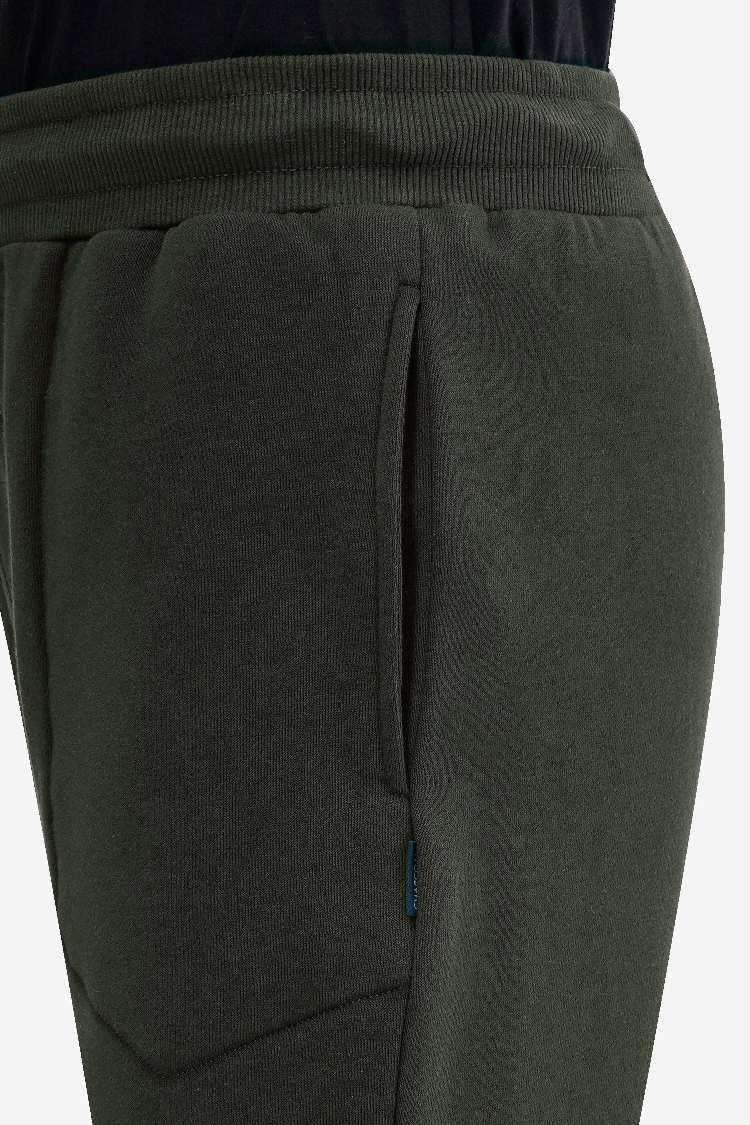 Dark olive terry fleece jogger leg with stitched seam and pocket panel