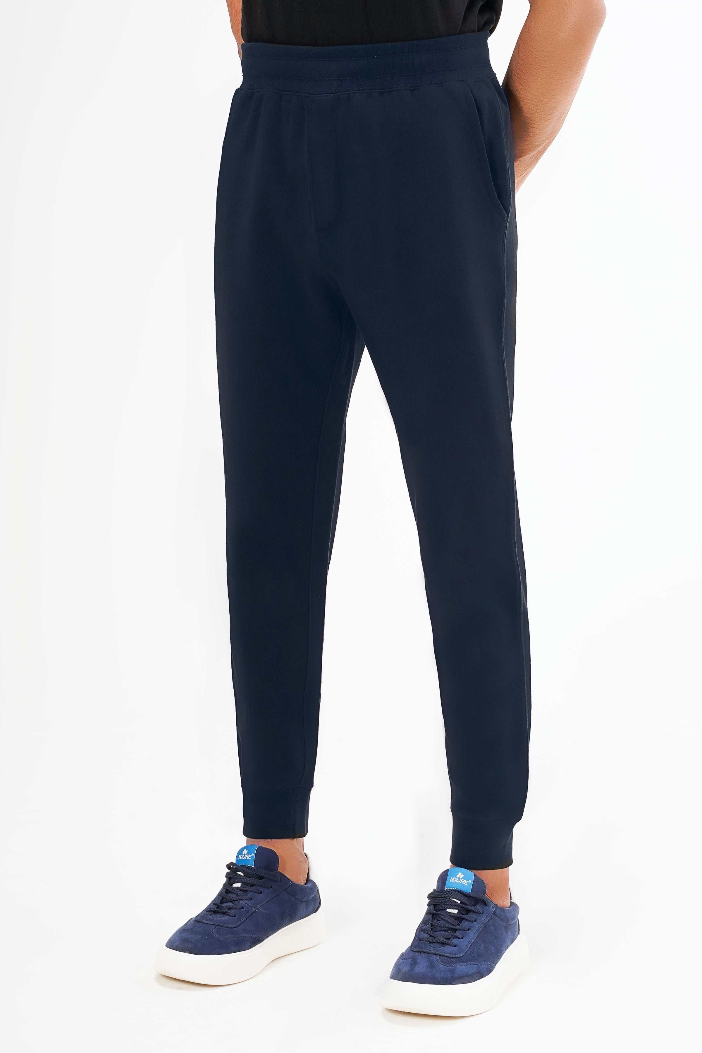 Navy terry jogger trousers with cuffed hems and side pockets