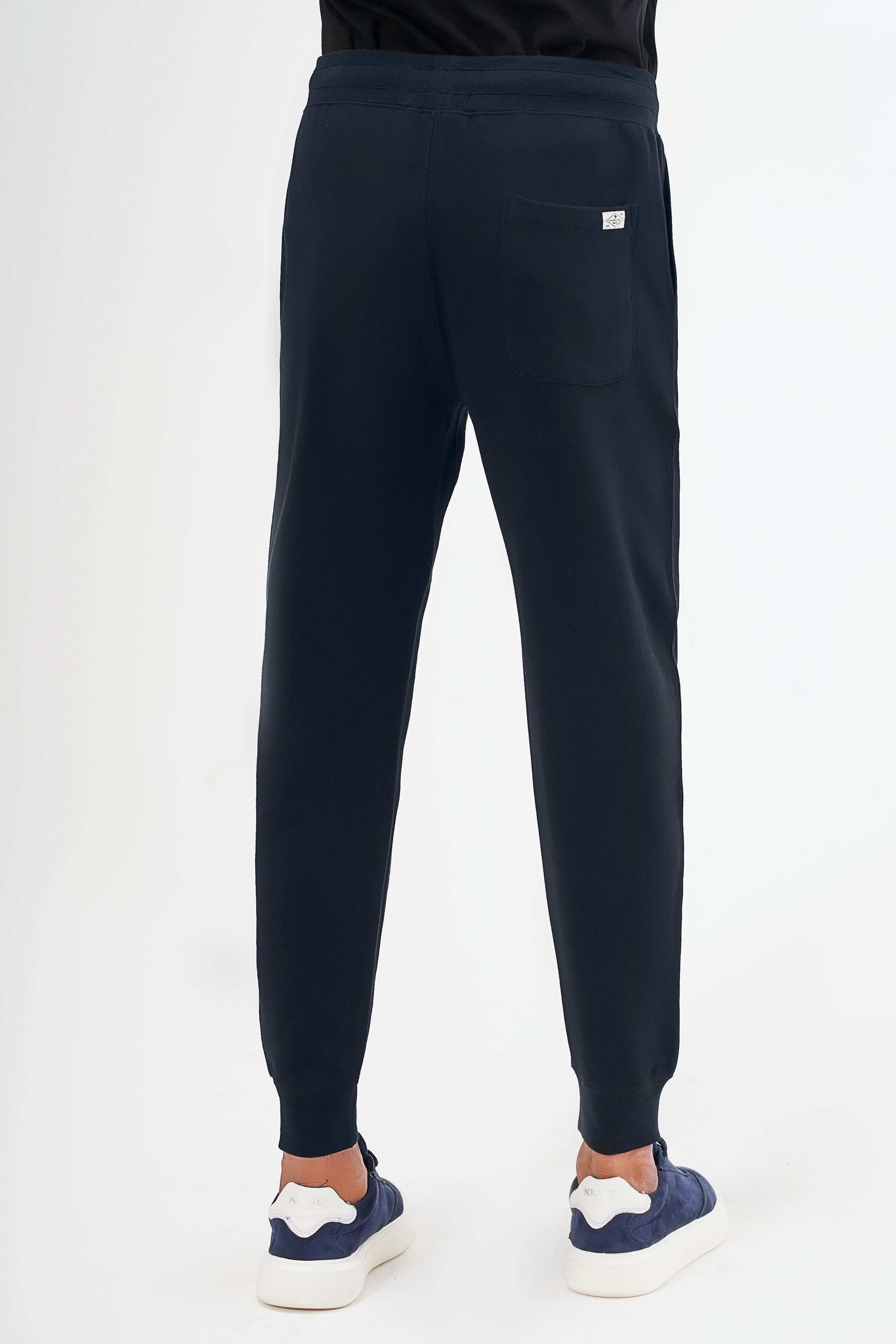 Navy terry jogger trousers with cuffed hems and back patch pocket