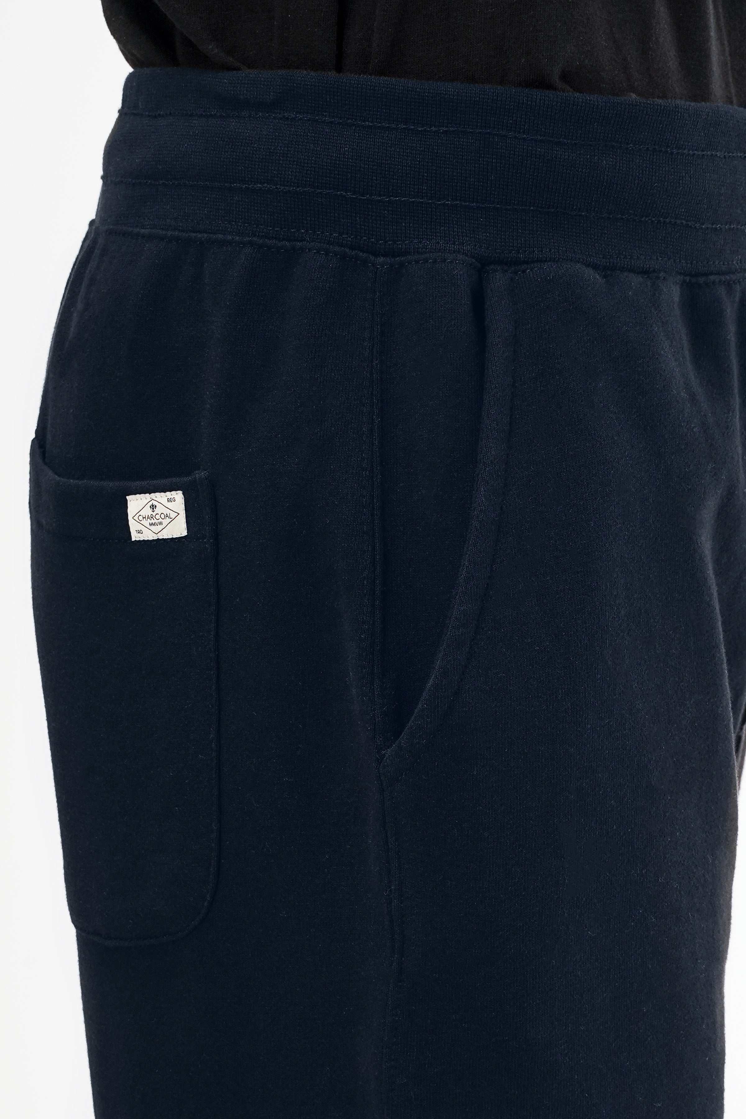 Navy terry jogger trousers close-up of side pocket and small patch label