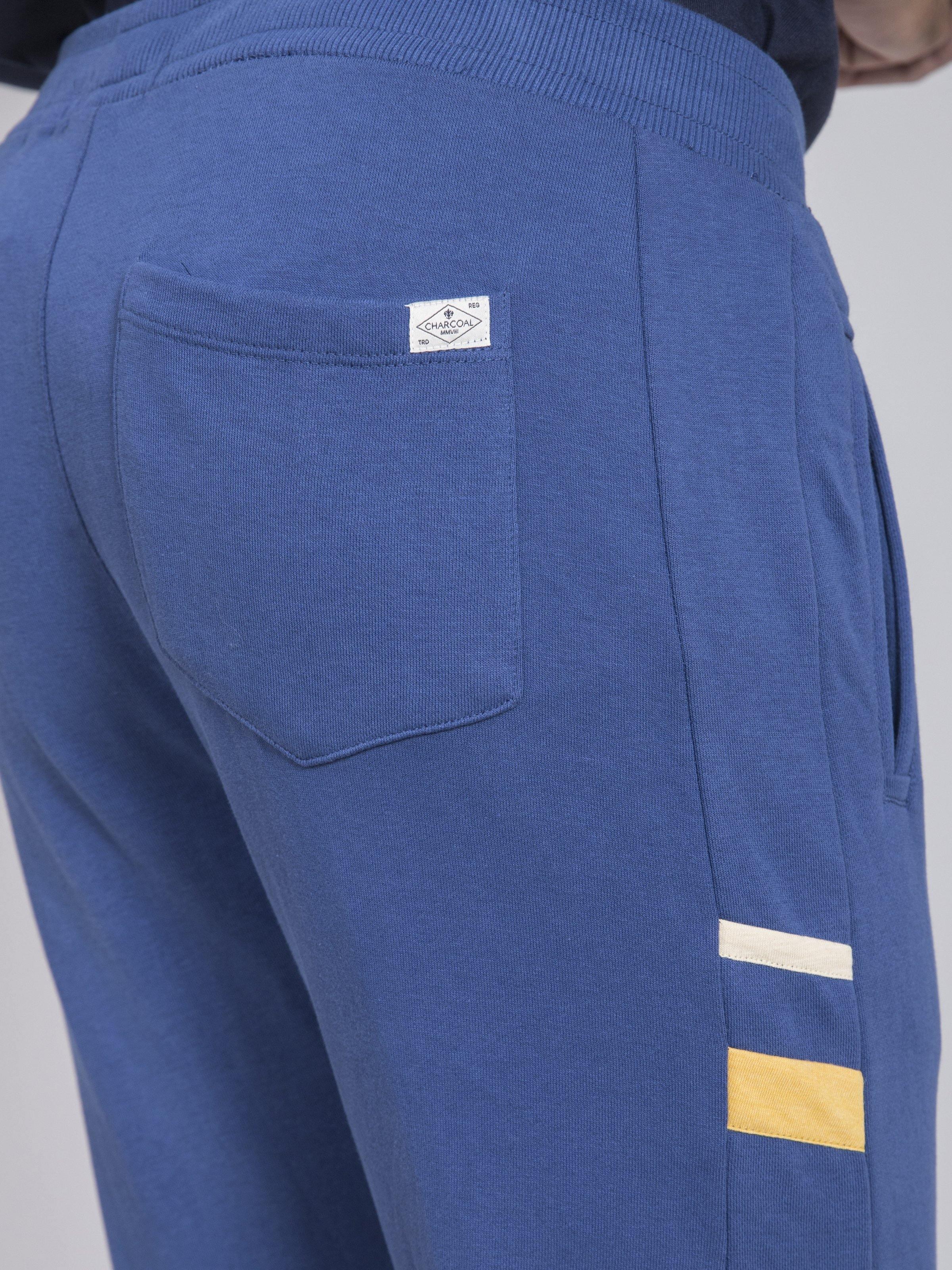 Blue terry trousers with back patch pocket and small logo label at hip
