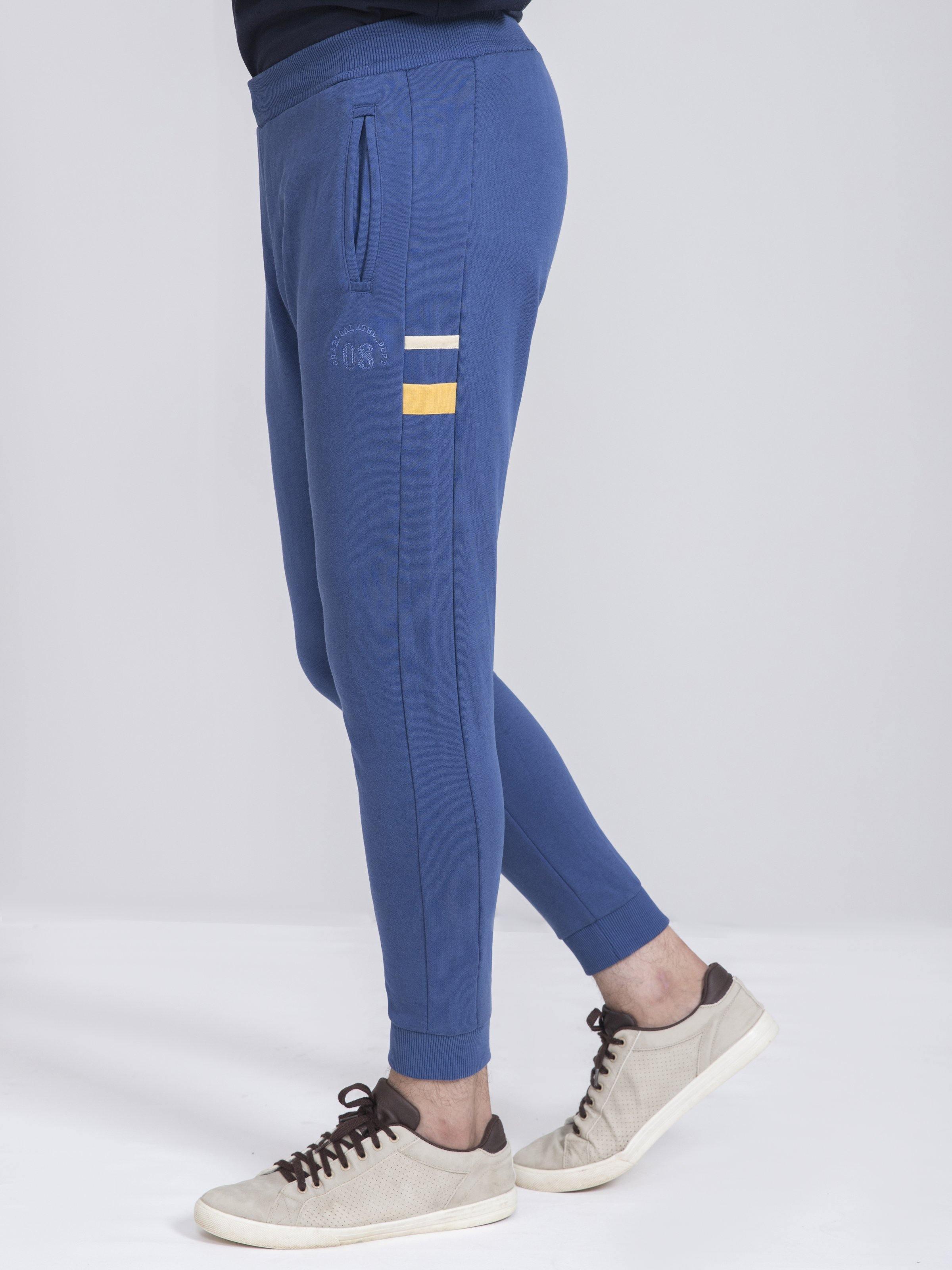 Slim-fit terry trousers in blue with drawstring waist and striped side patch
