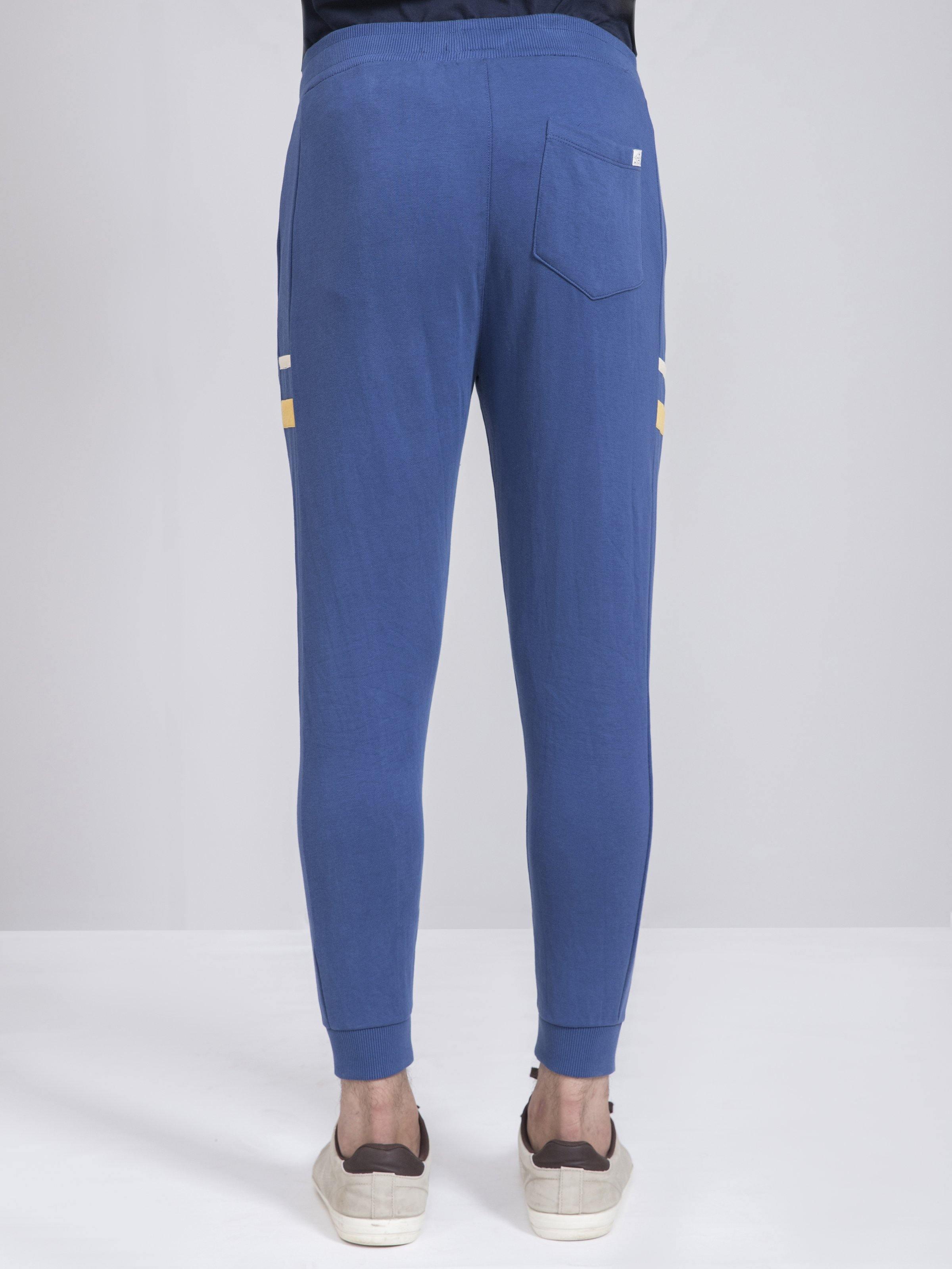 Slim-fit terry trousers in blue, back view with rear patch pocket