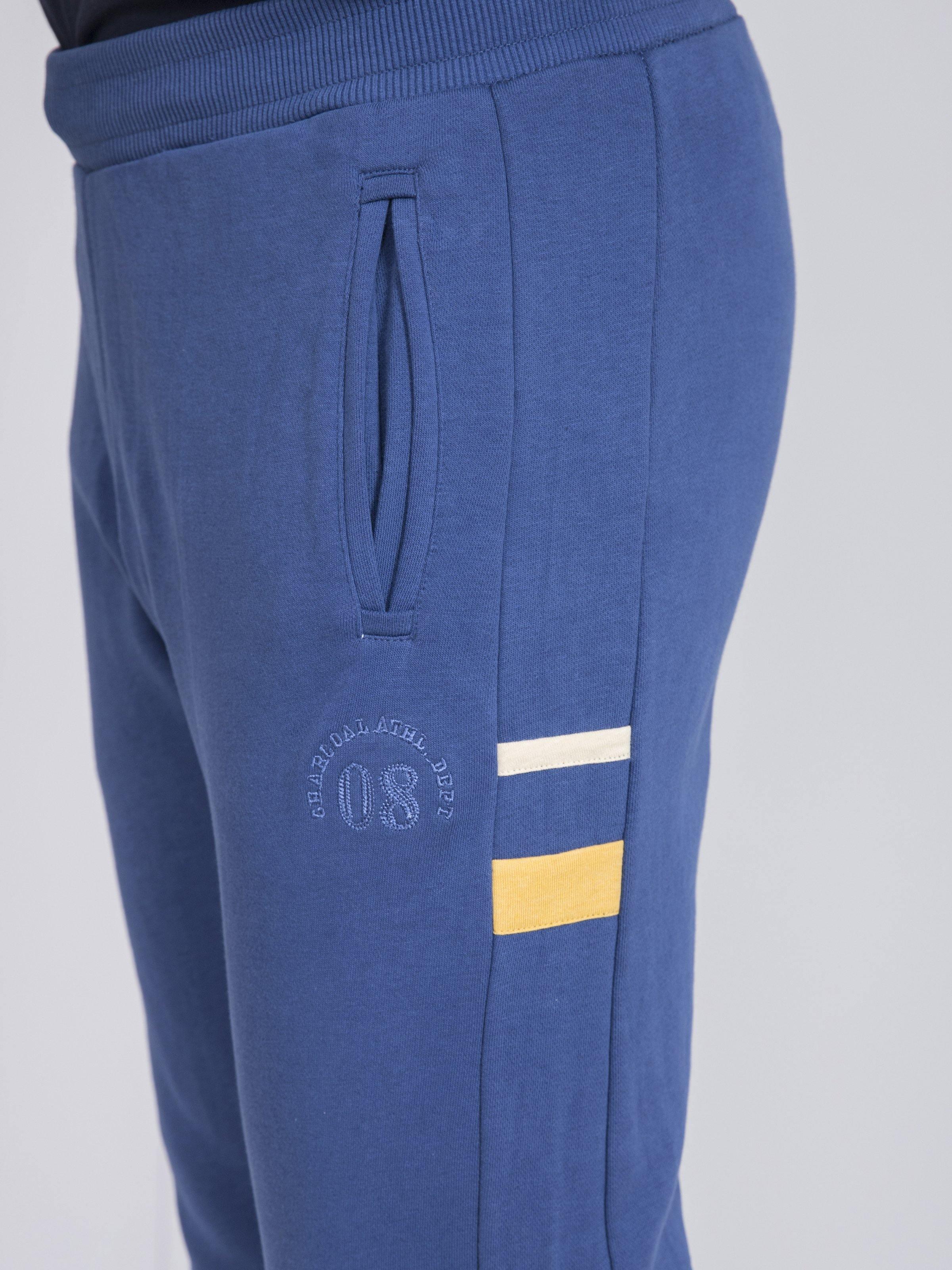 Blue terry slim trousers with drawstring waist, rear welt pocket, striped detail