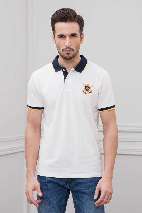 White tipping polo shirt with navy collar trim and crest emblem