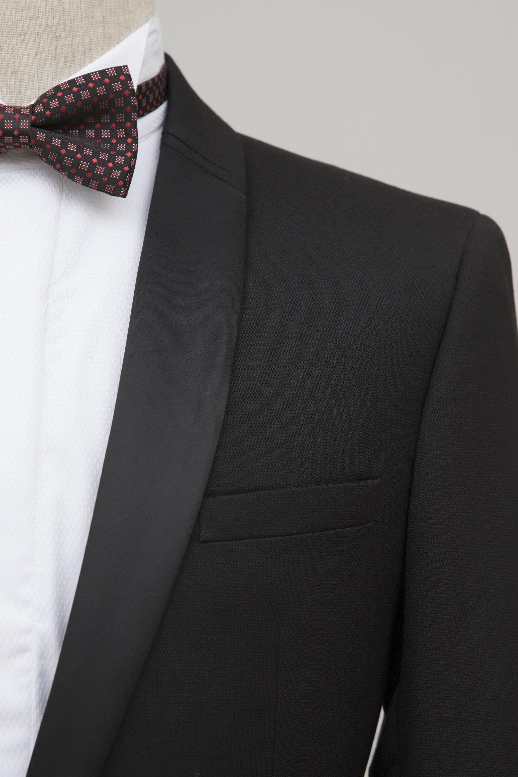 Black tuxedo suit jacket lapel with welt pocket and buttoned collar