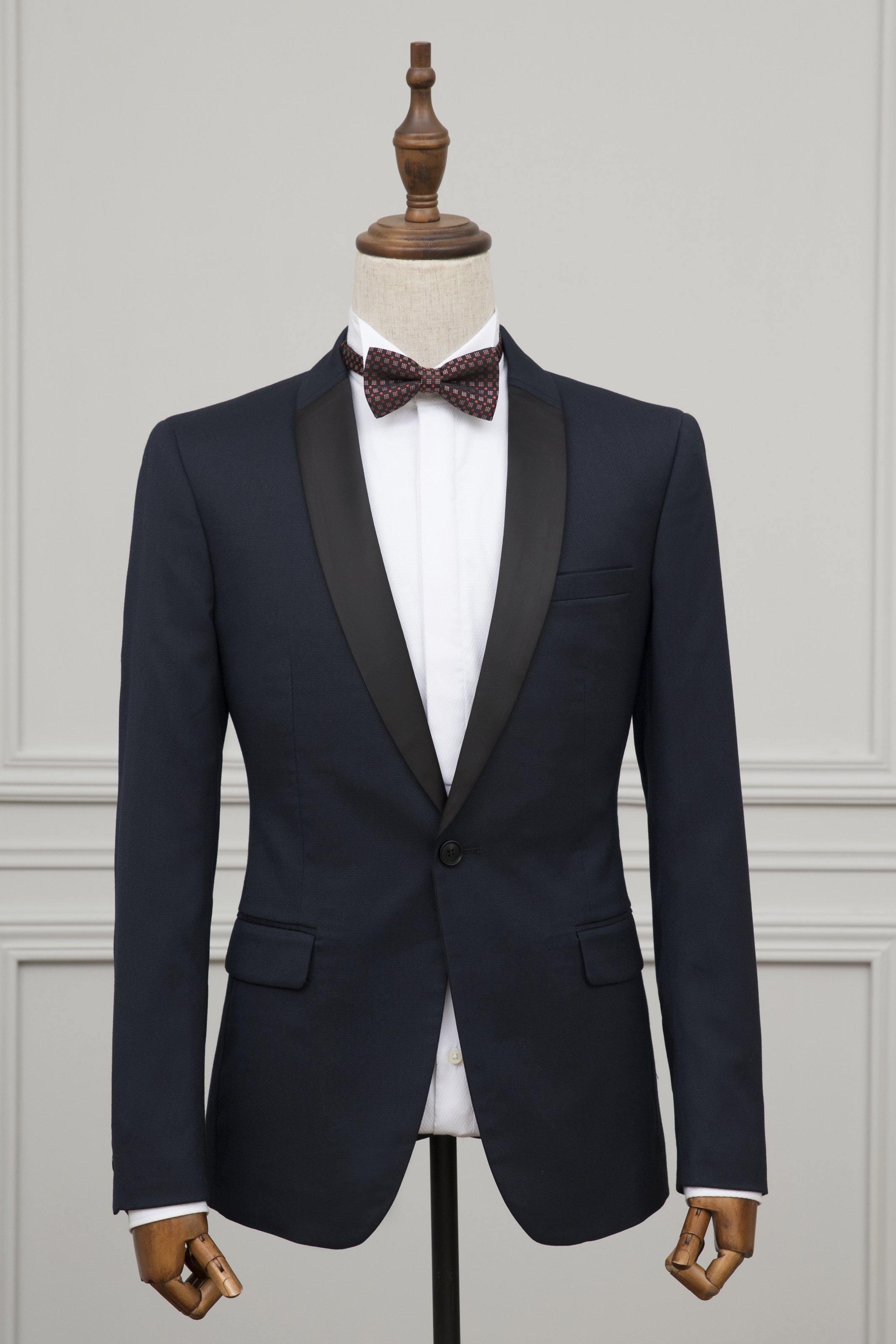 Navy 1-button tuxedo jacket with satin lapels and bow tie on mannequin