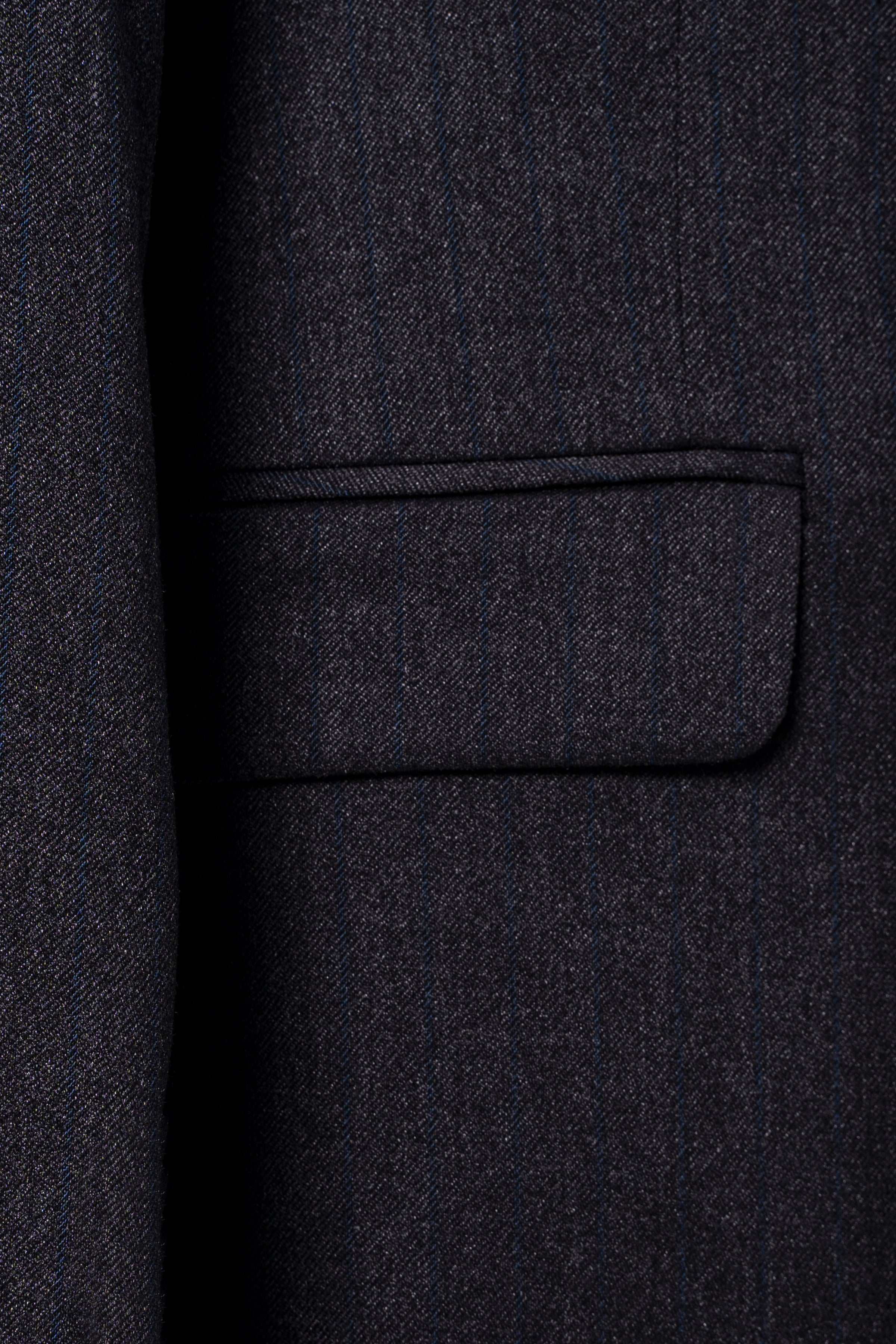 Charcoal suit jacket chest pocket flap close-up