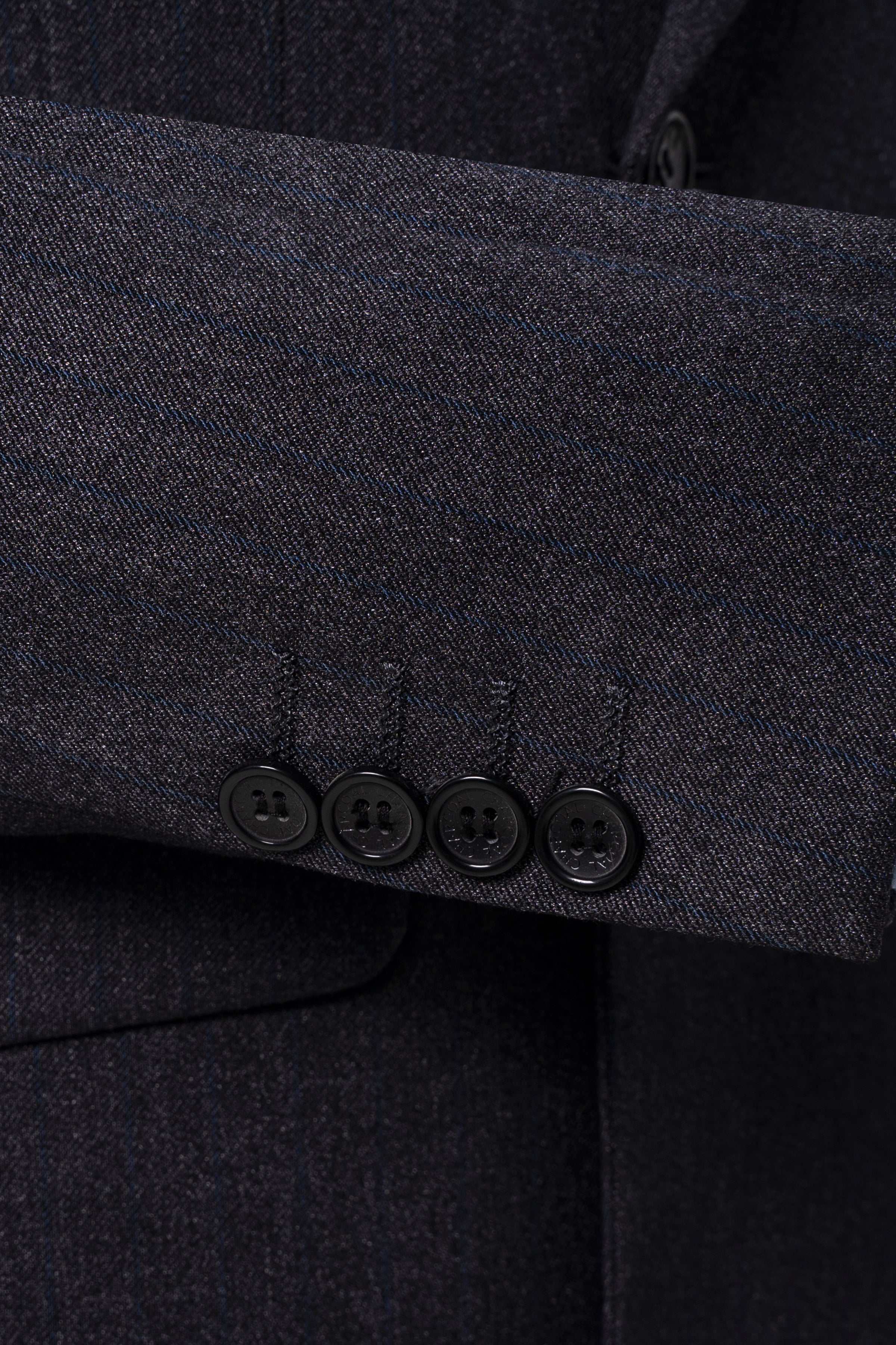 Charcoal suit jacket sleeve cuff and four-button cuff placket close-up