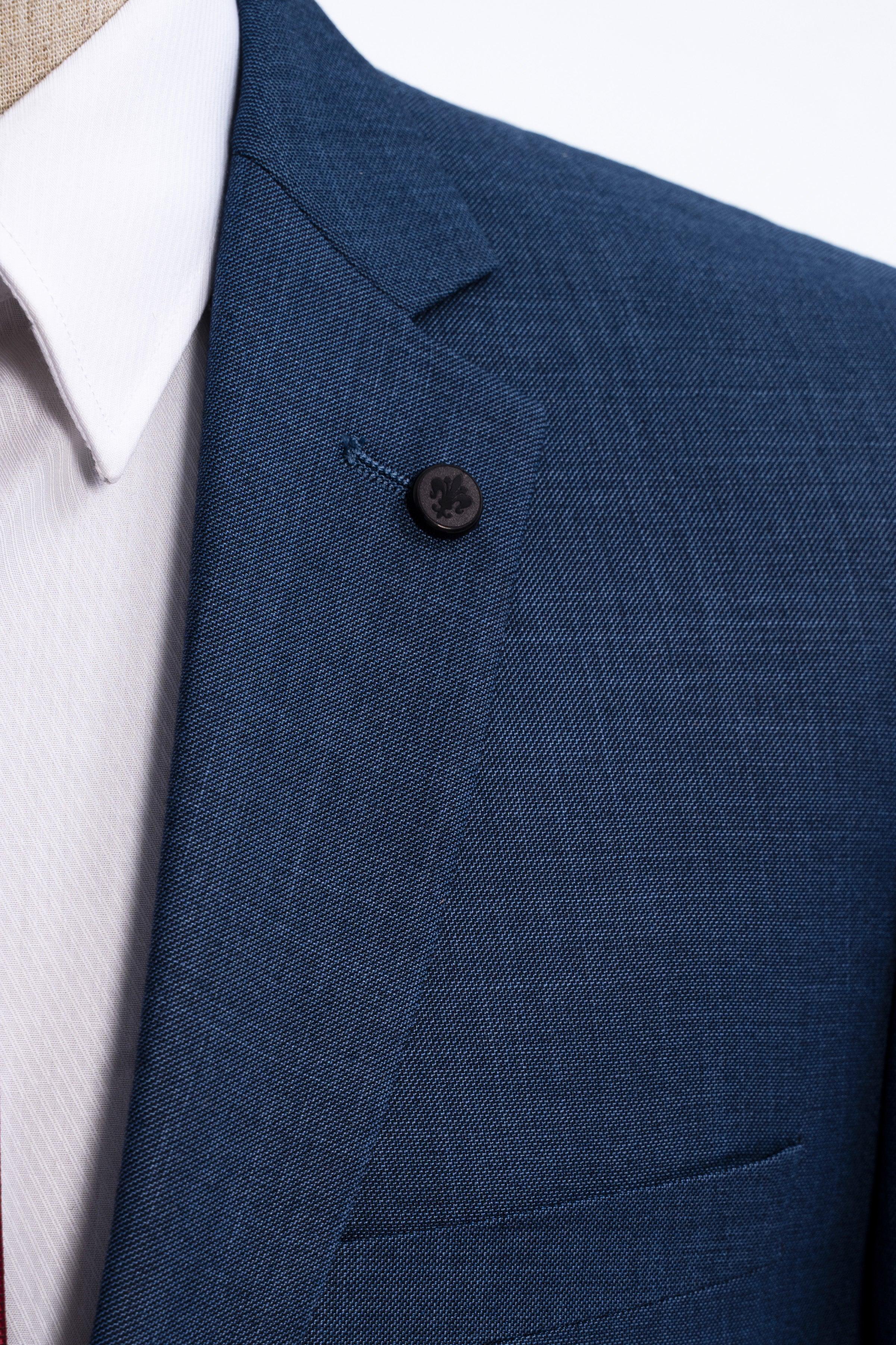 Blue suit jacket lapel with dark button and breast pocket