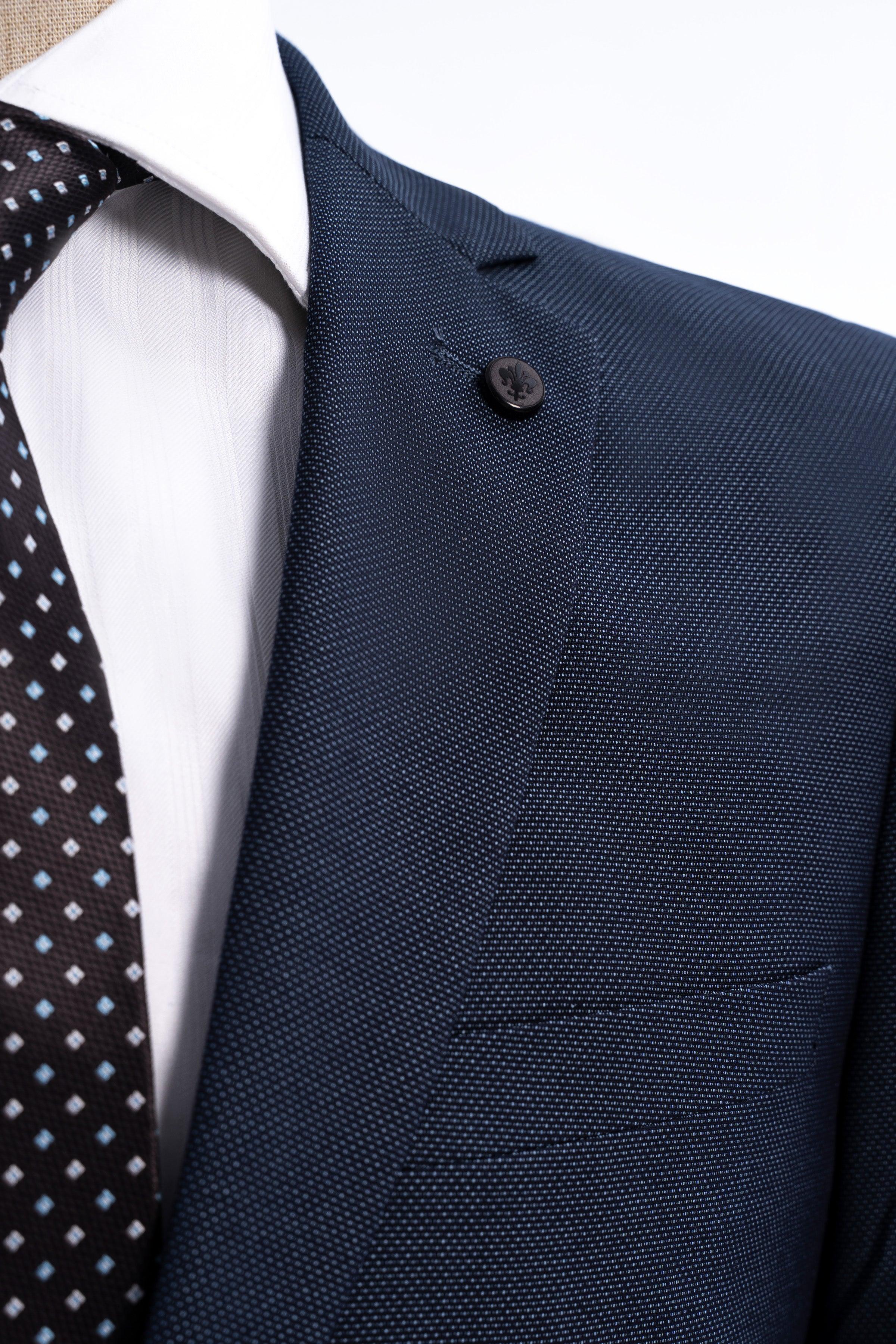 Dark blue suit jacket lapel with one button and textured front pocket area