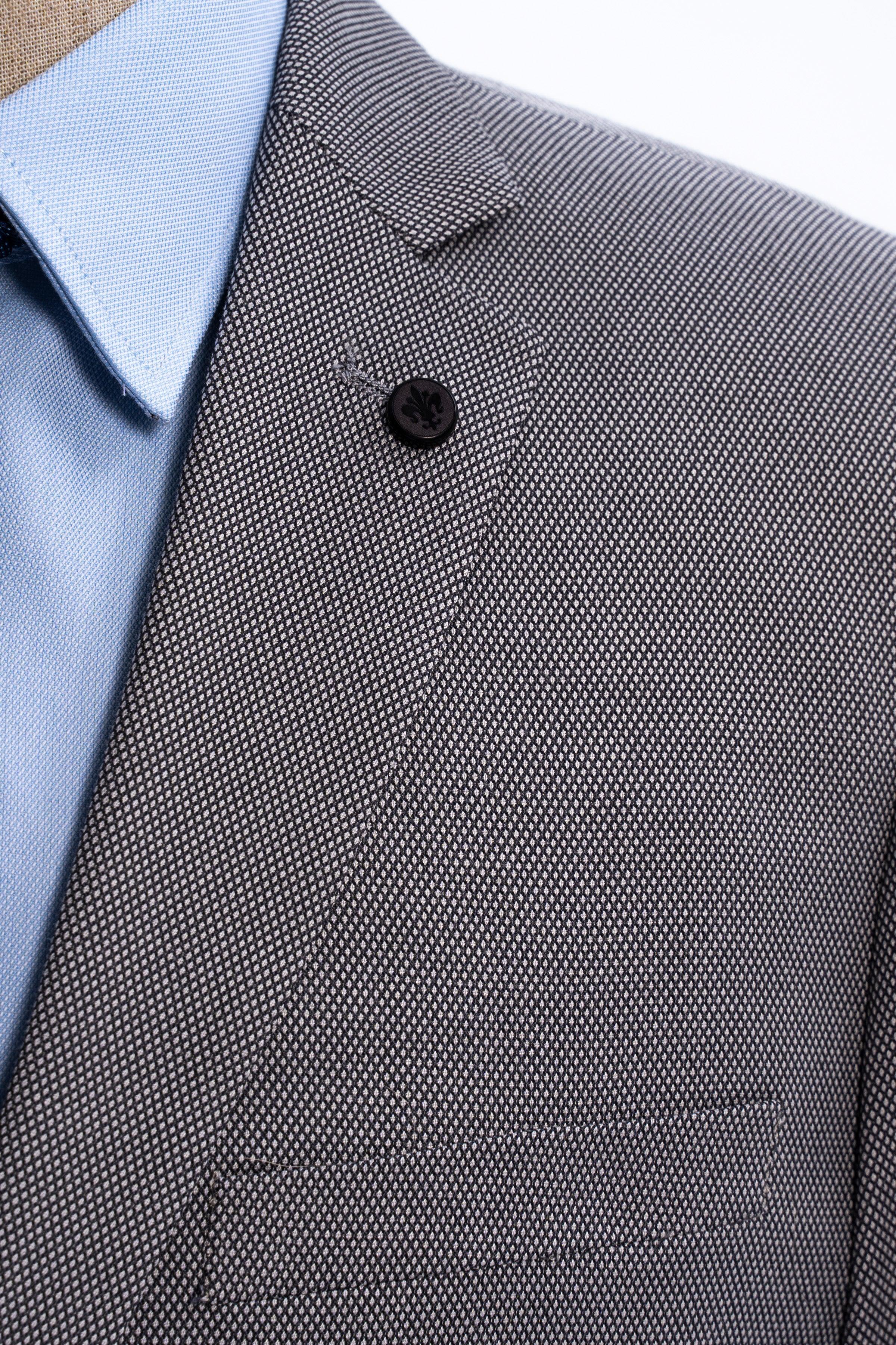 Suit jacket collar and lapel in medium gray with single button detail