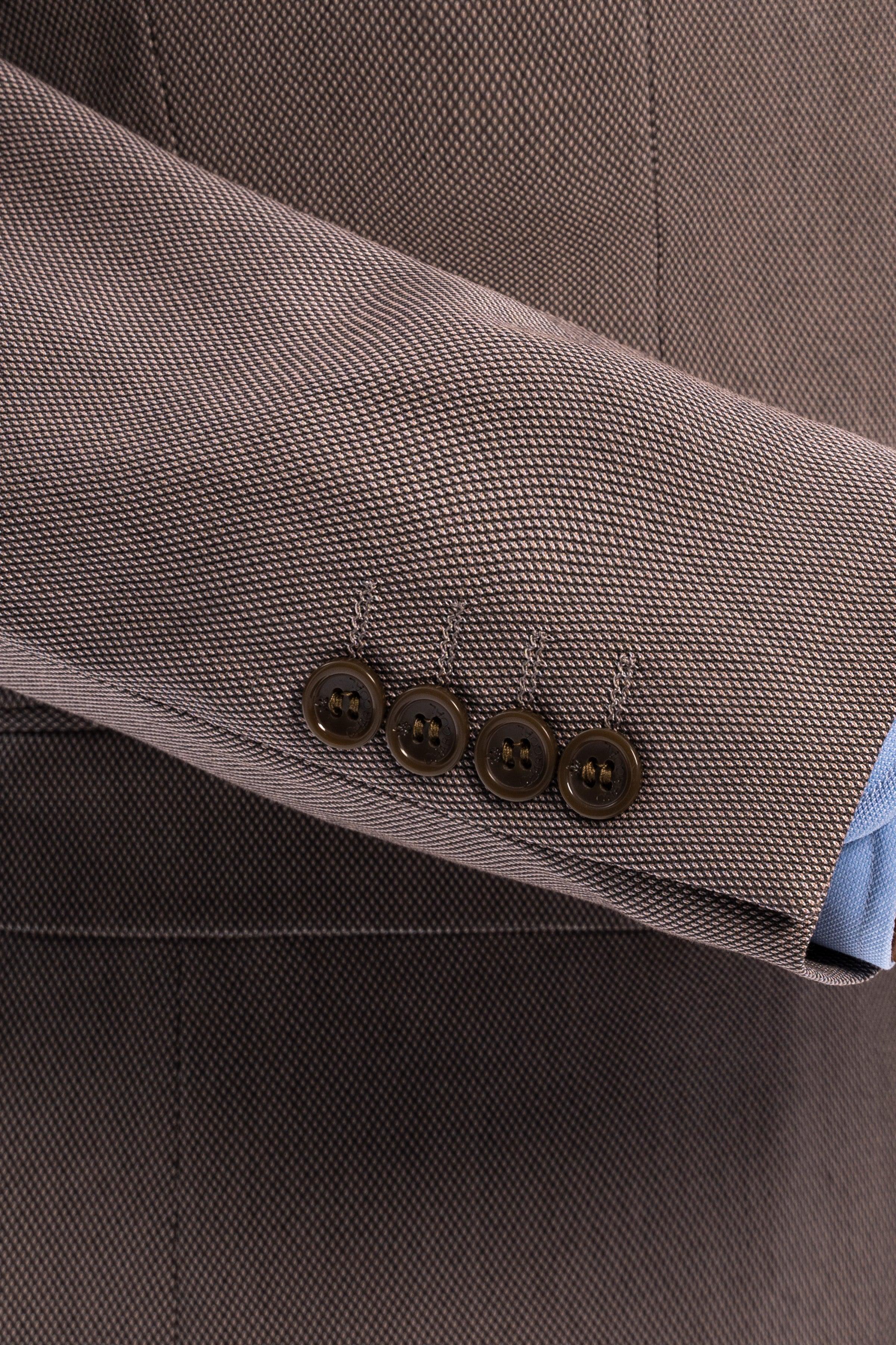 Taupe suit jacket sleeve cuff with four button closures