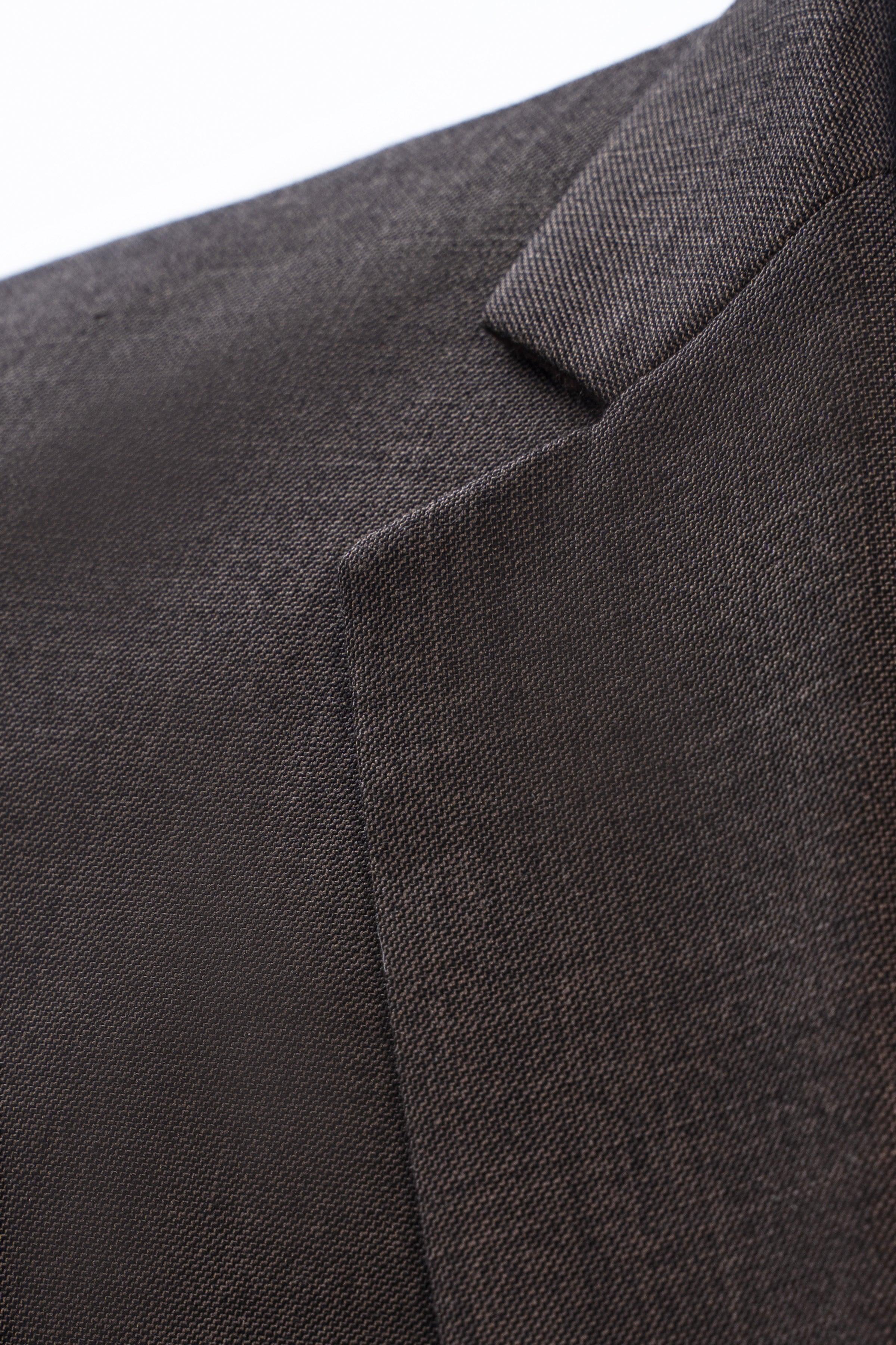 Close-up of dark olive suit jacket shoulder and lapel fabric texture