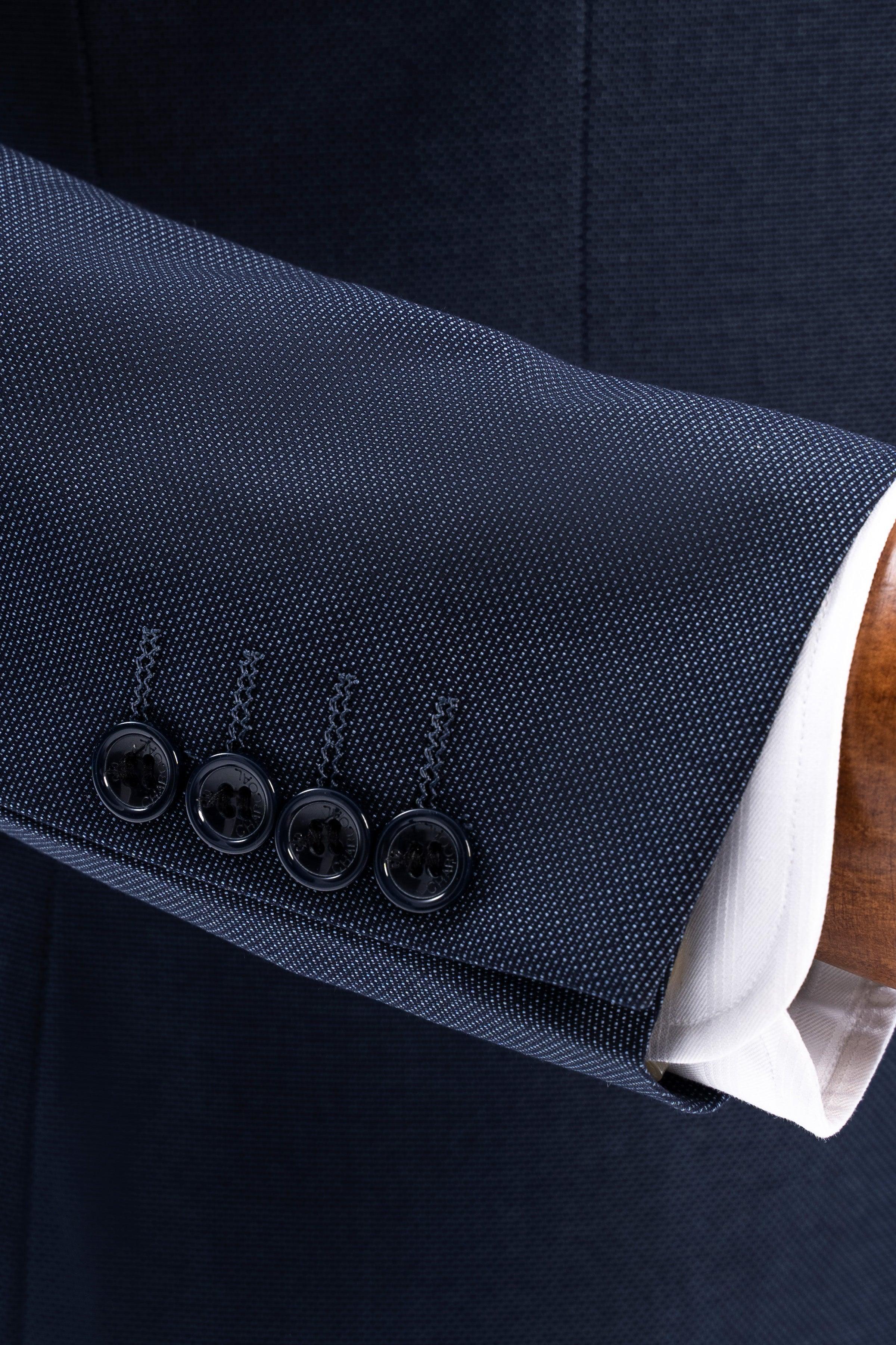 Dark blue suit cuff with four buttons and fine textured weave