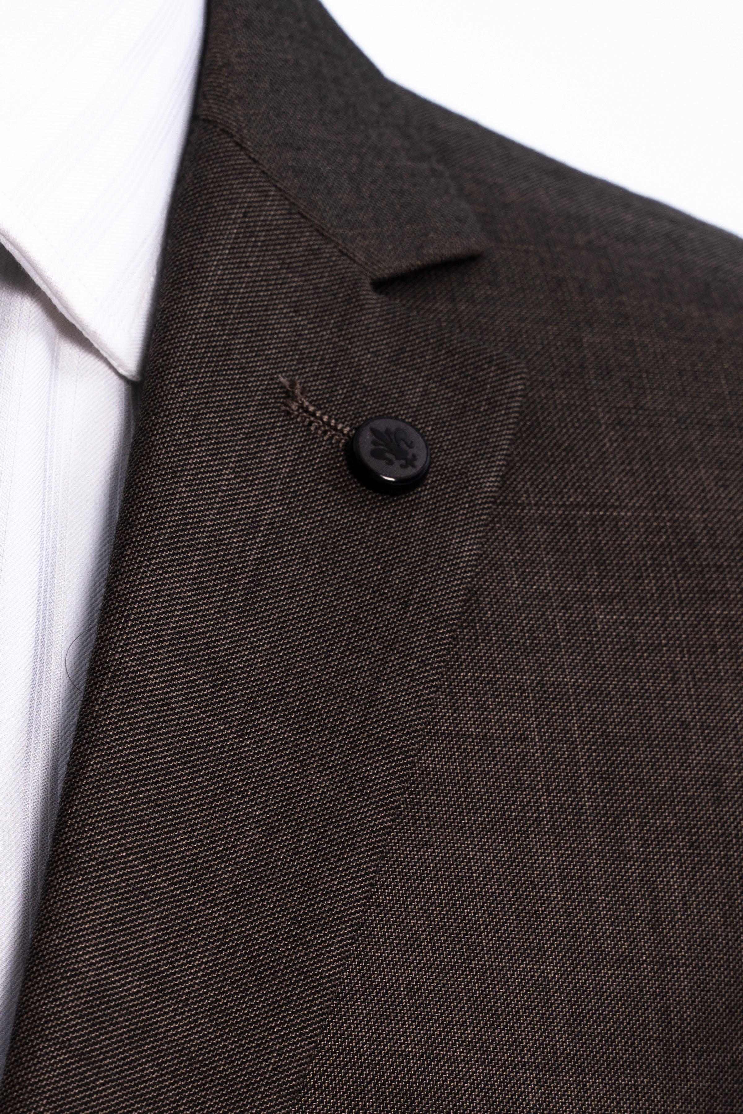 Close-up of dark olive suit jacket front button and textured lapel fabric