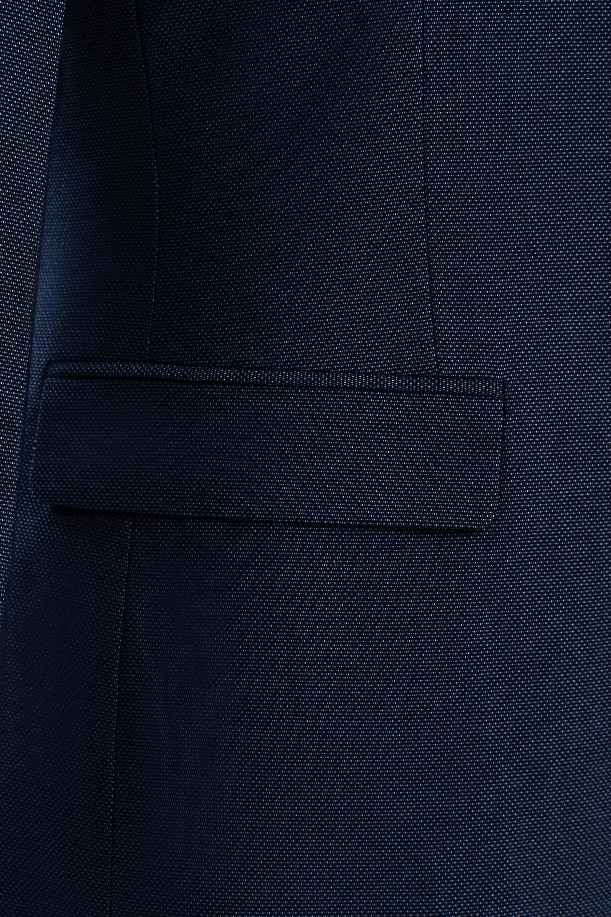 Dark blue suit trousers waistband and front pocket with neat stitching