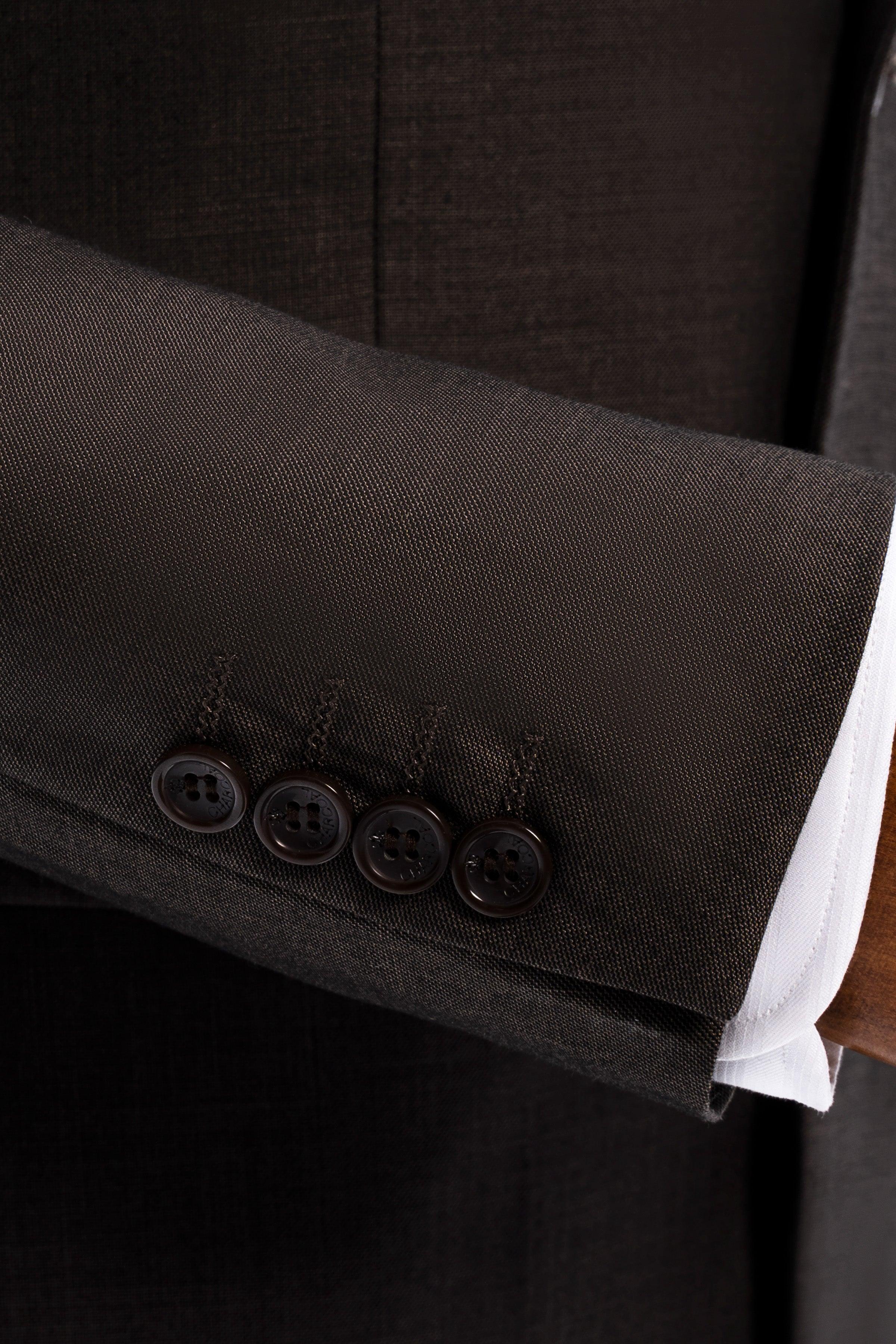 Suit jacket cuff with dark buttons and white shirt sleeve