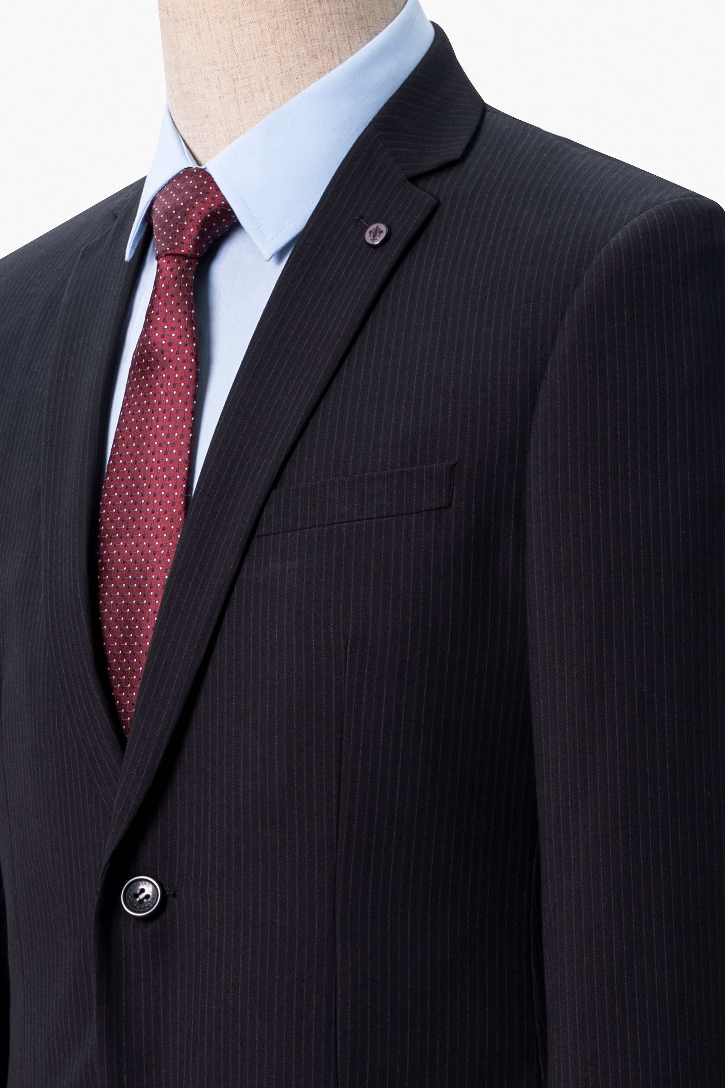 Black suit blazer lapel with red patterned tie