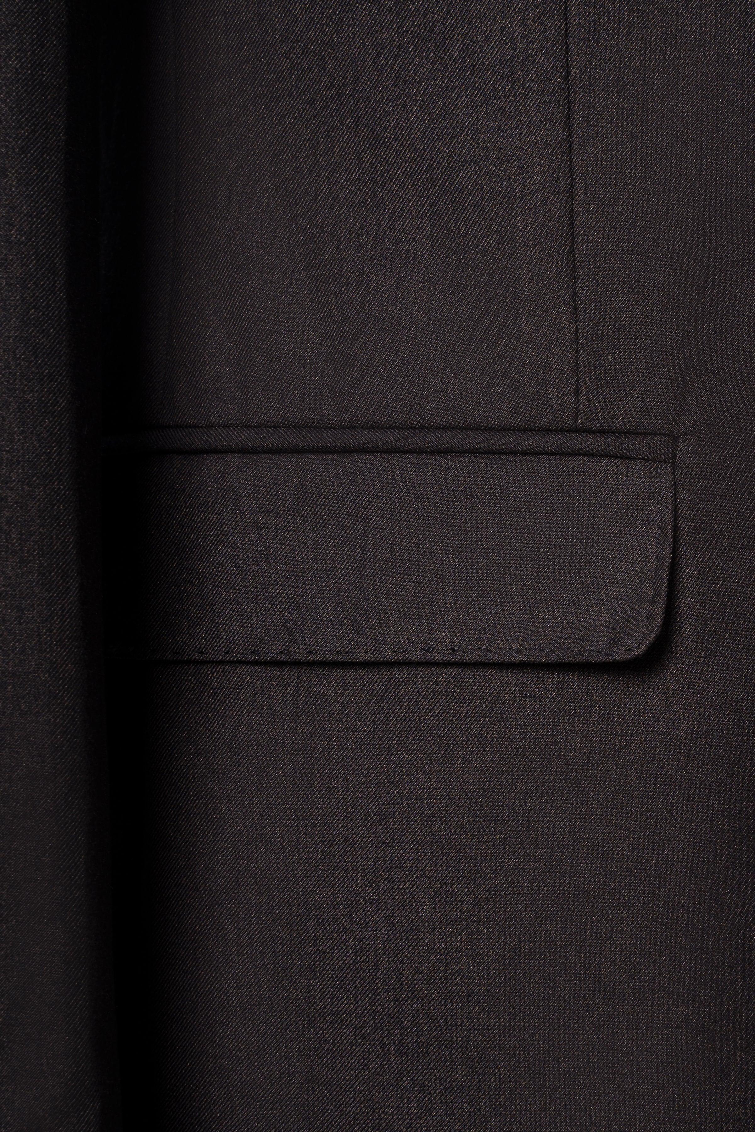 Suit jacket chest pocket with flap on dark brown fabric