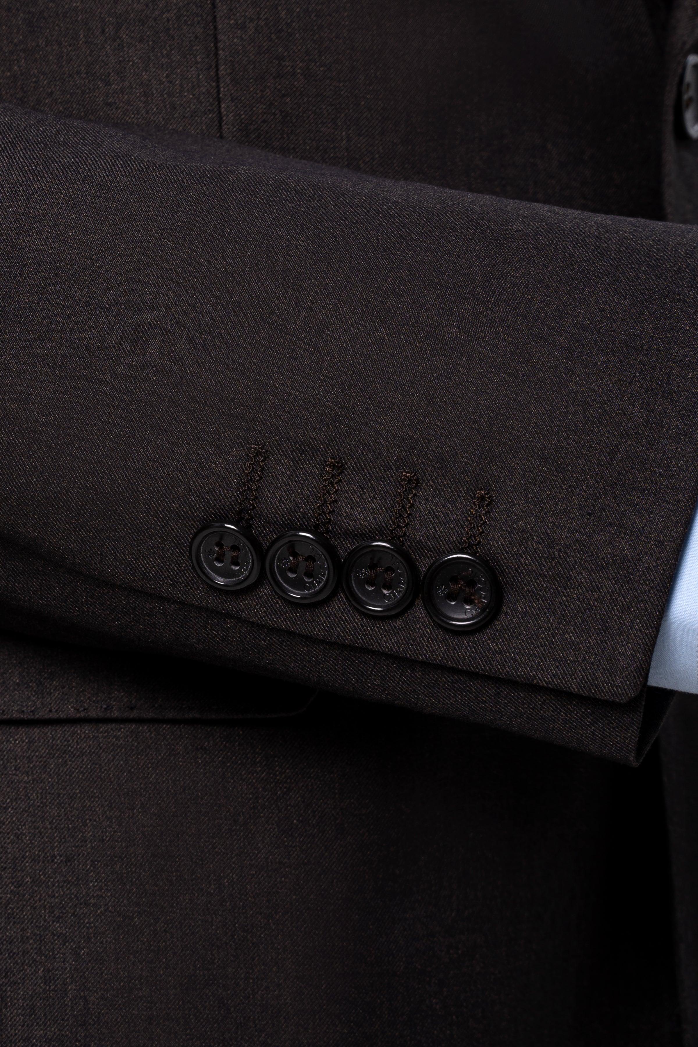 Suit jacket cuff and button detail on dark brown fabric