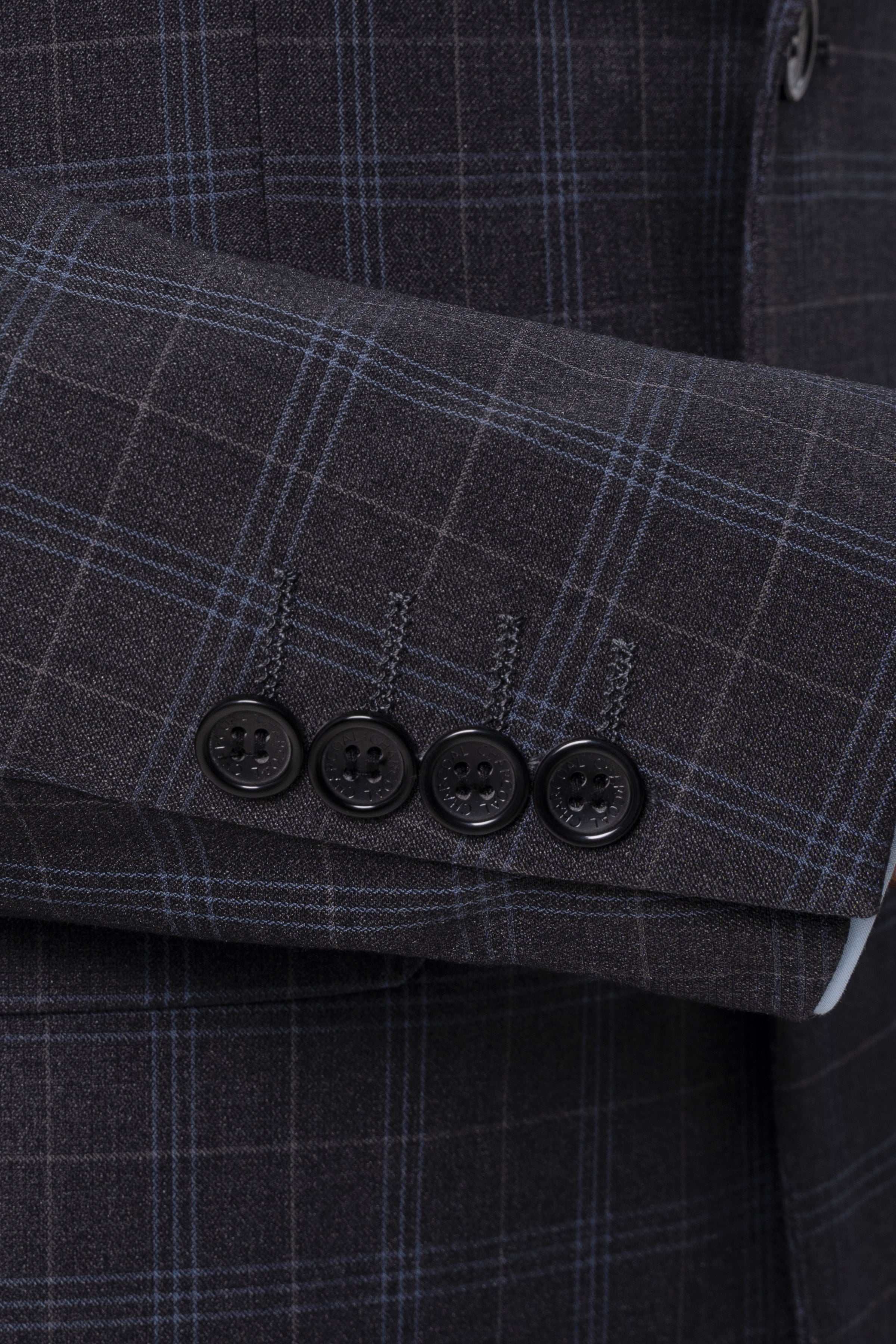 Charcoal check suit jacket cuff, buttoned sleeve with four dark buttons
