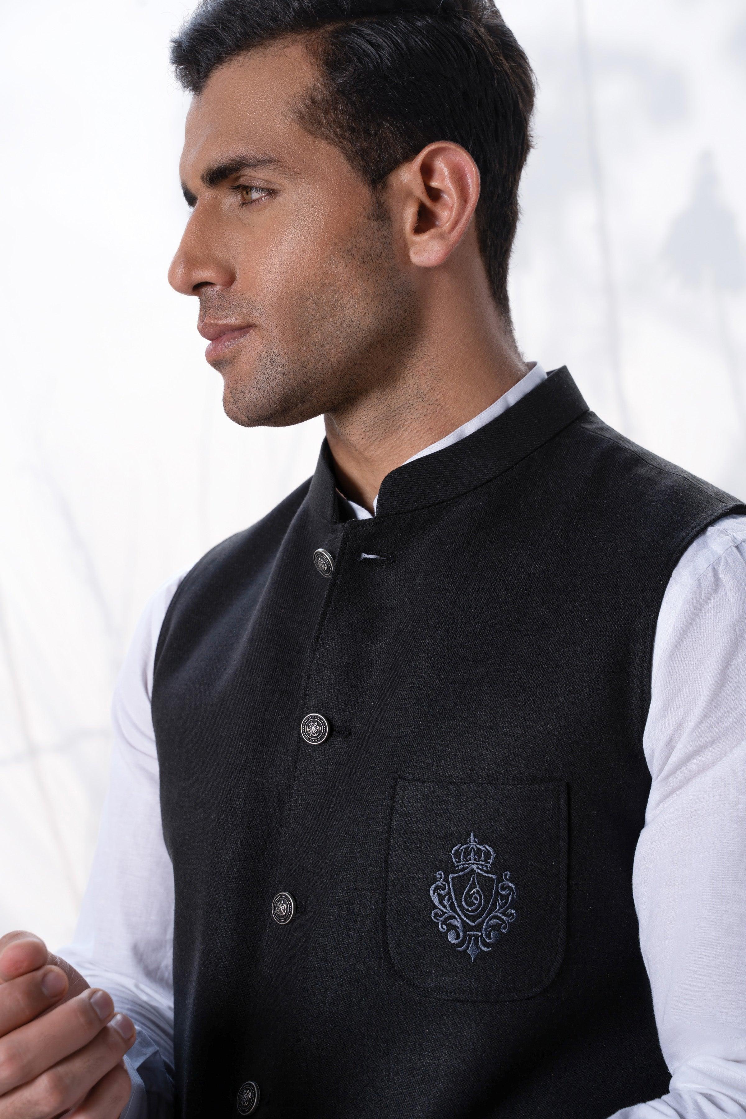 Men's black waistcoat close-up with button placket and crest chest pocket