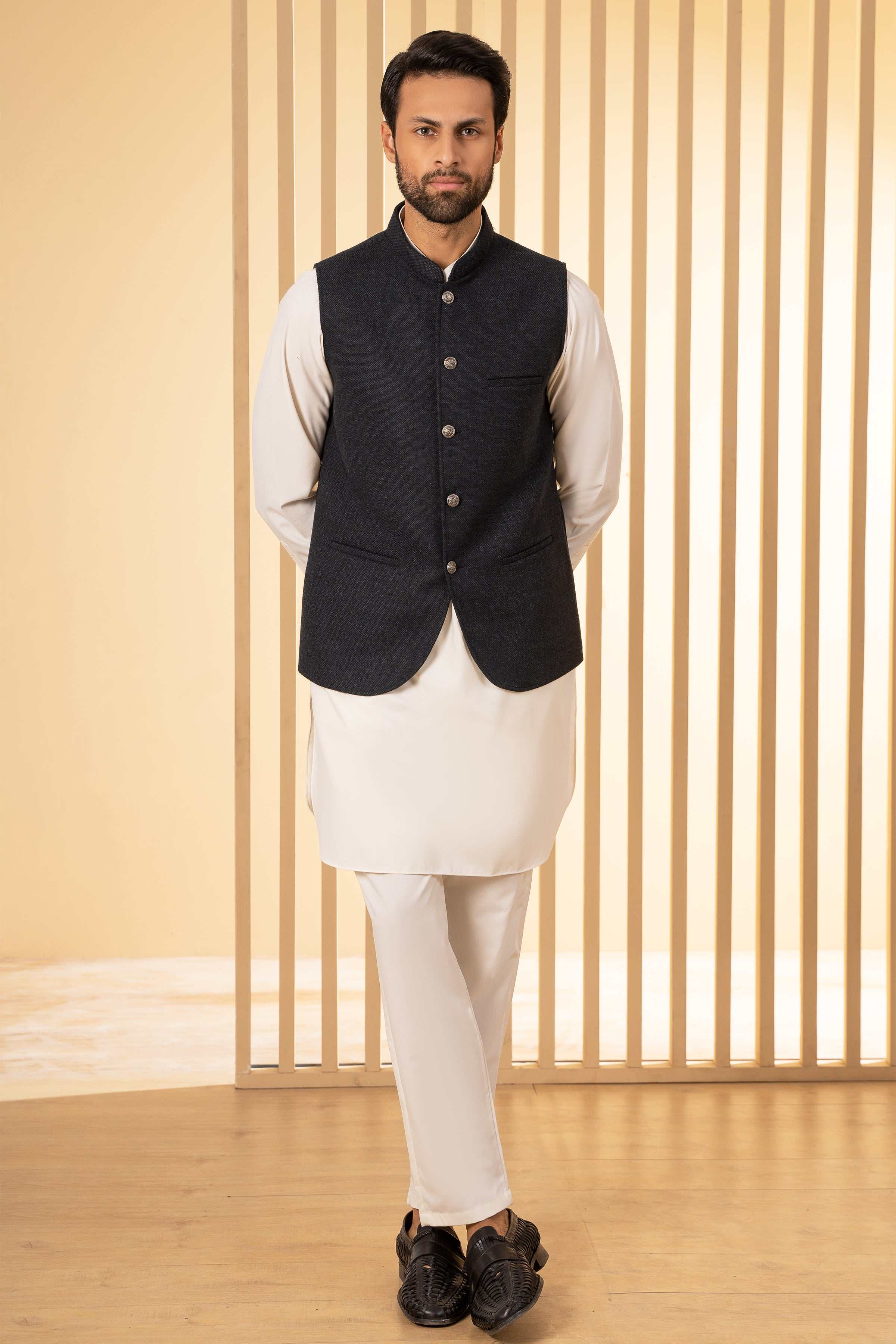 Blackish-blue waistcoat with stand collar and front buttons, side hem in view.
