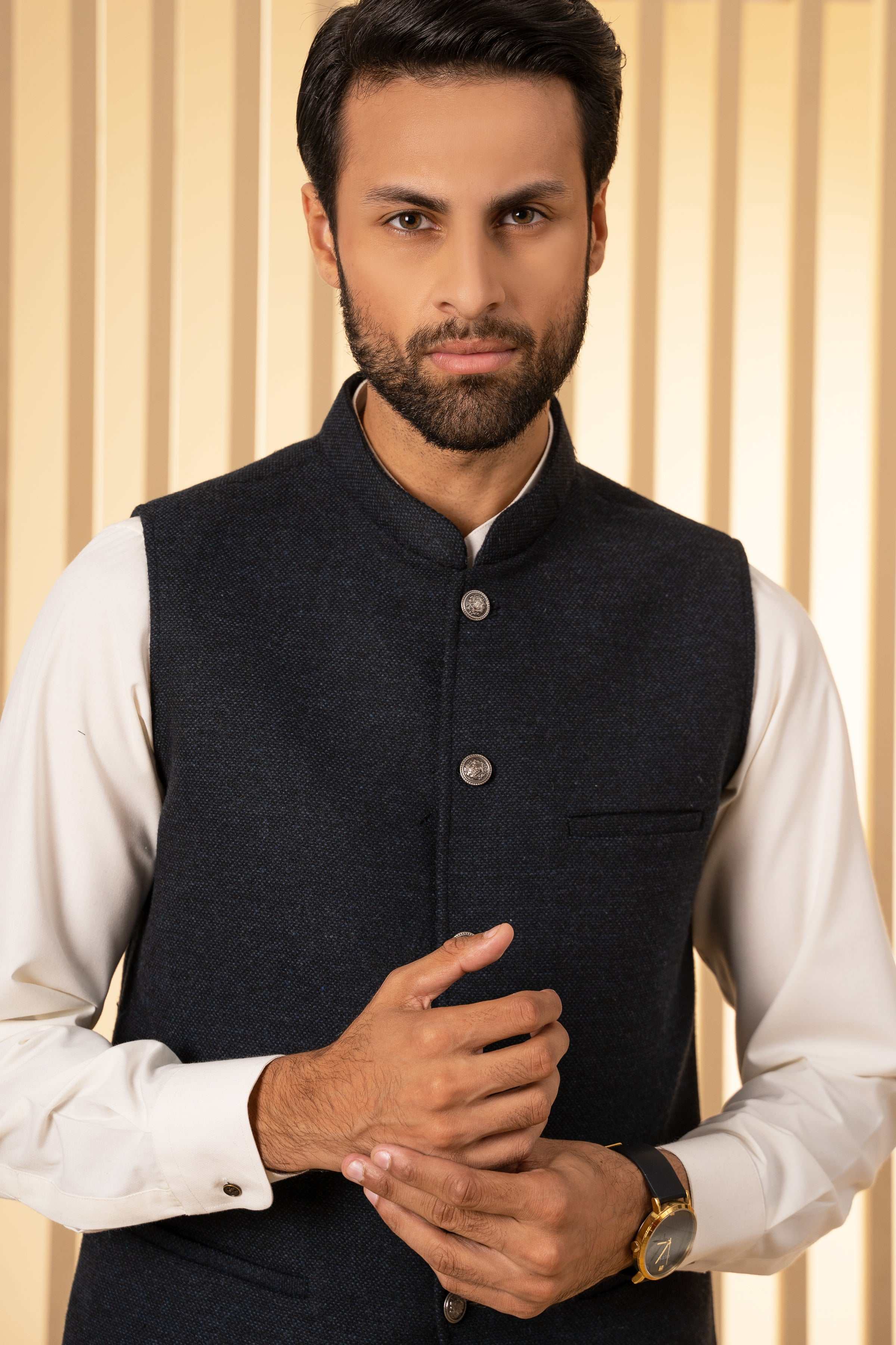 Blackish-blue waistcoat with stand collar, metal buttons, and chest pocket detail.