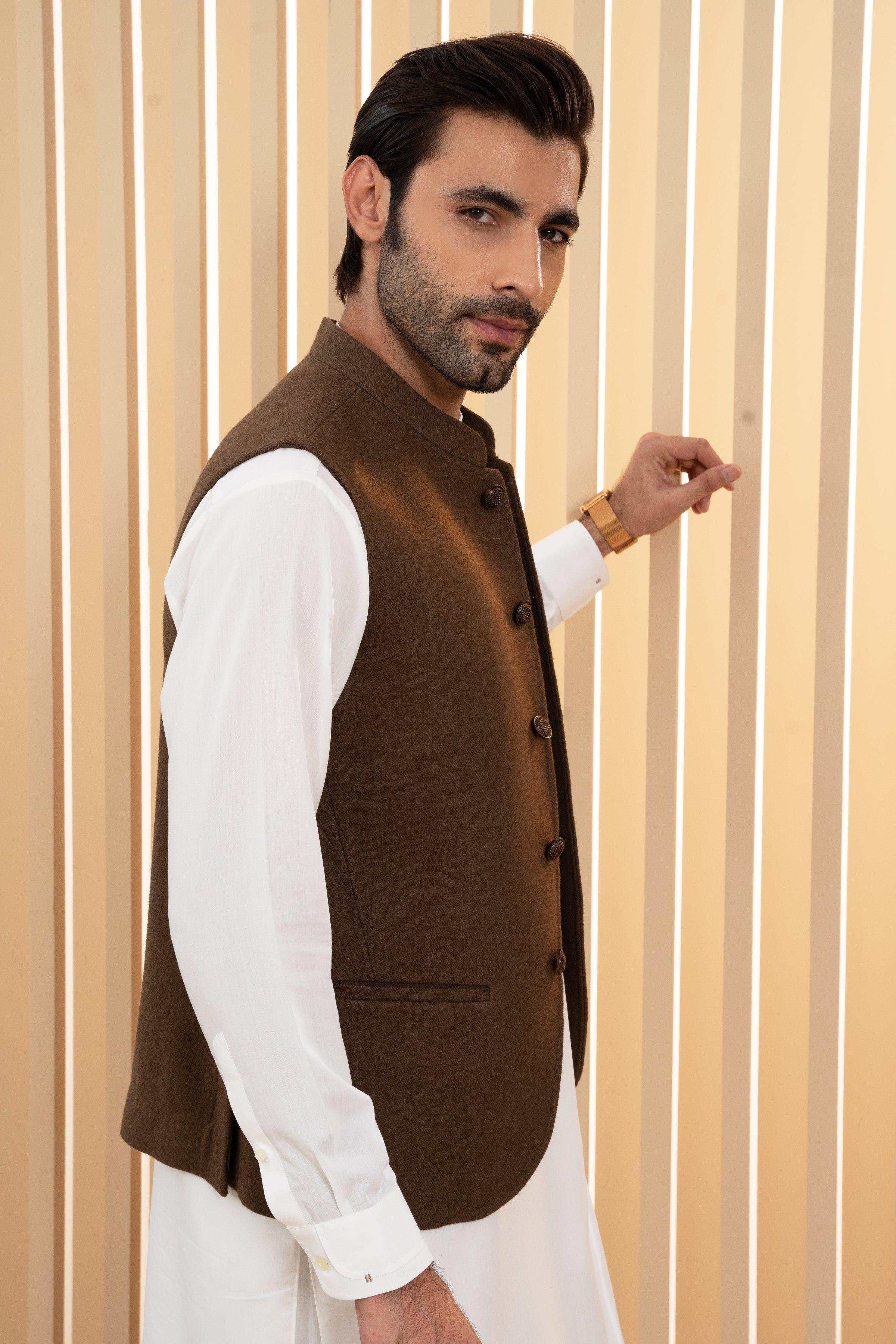 Dark olive waistcoat with side pocket and dark buttons, side view over white sleeve