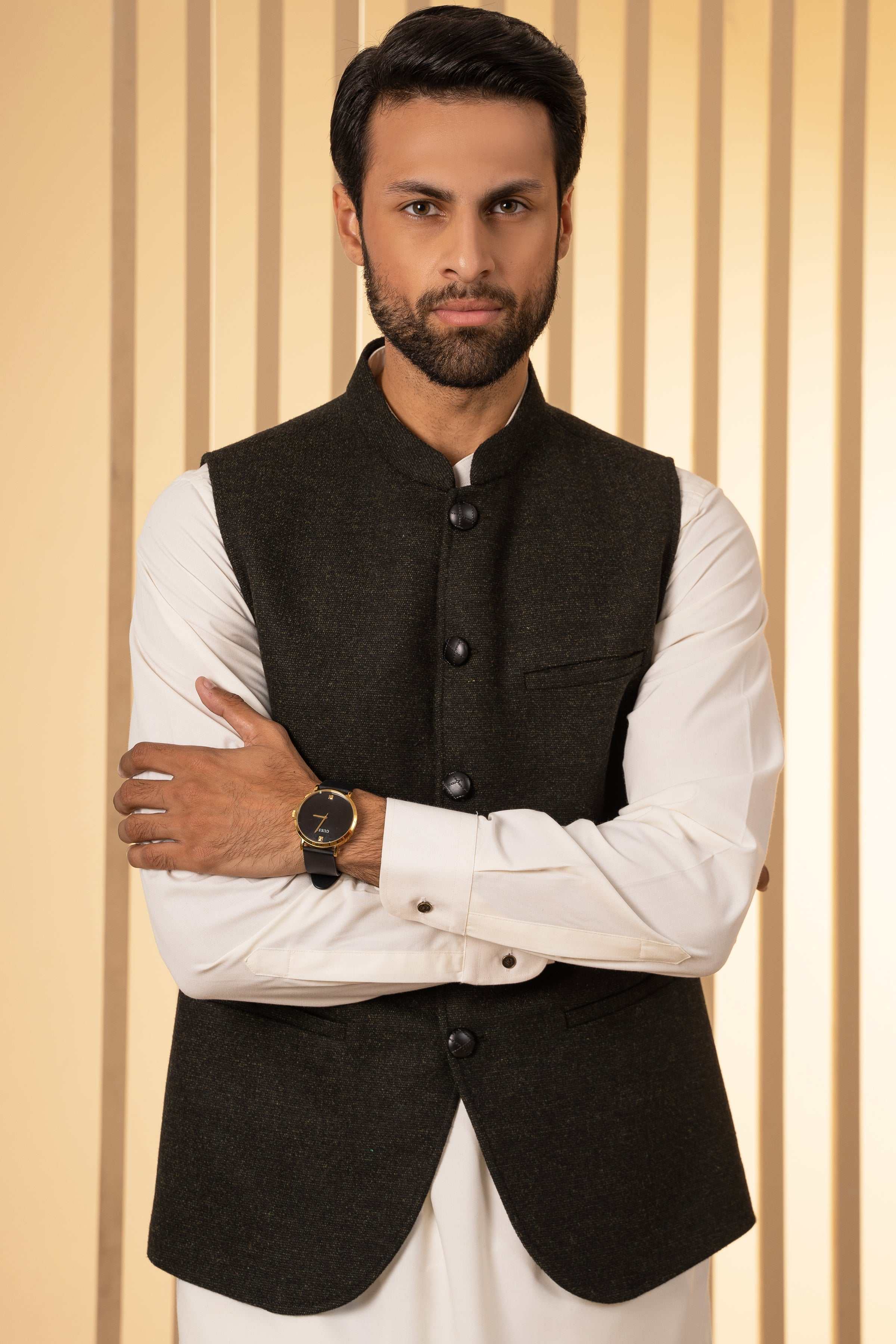 Mens dark green waistcoat with button-front and front pockets, arms crossed