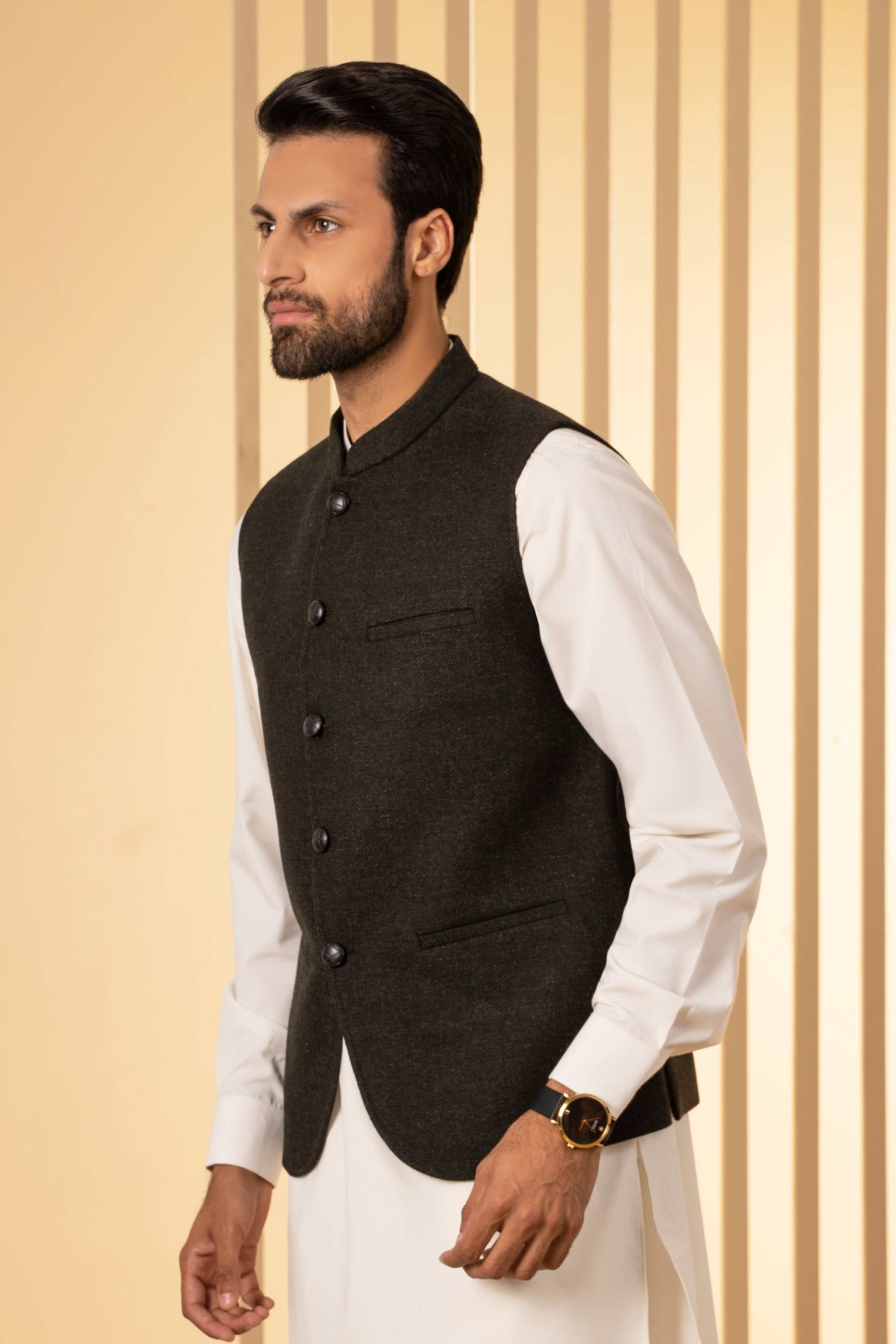 Mens dark green waistcoat with button-front and chest pockets, side view