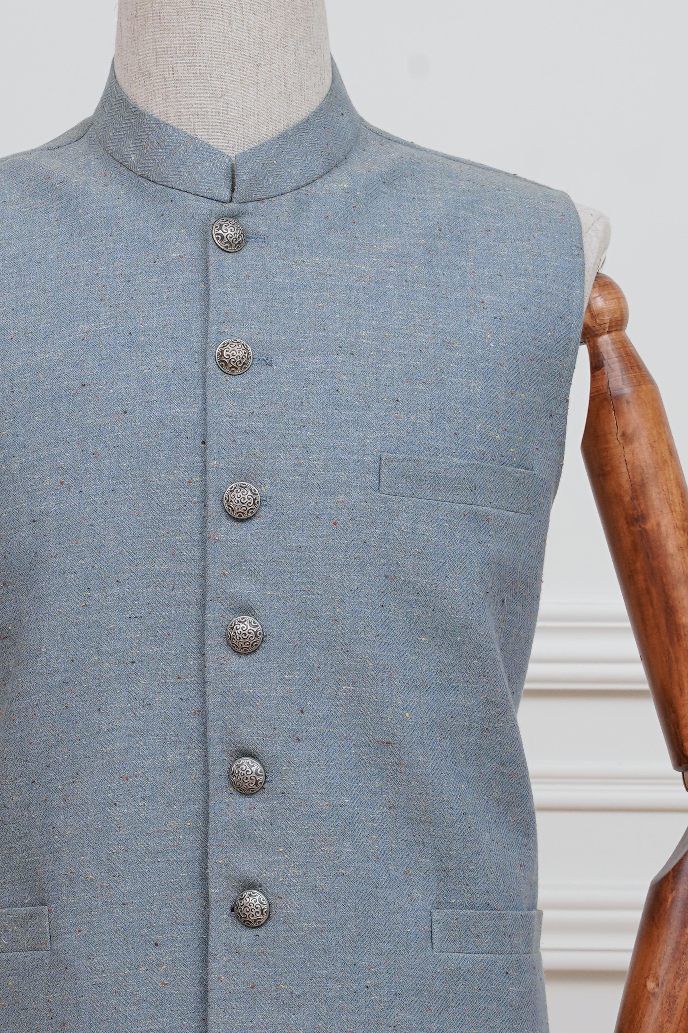 Light blue waistcoat close-up: high collar and round metal buttons.