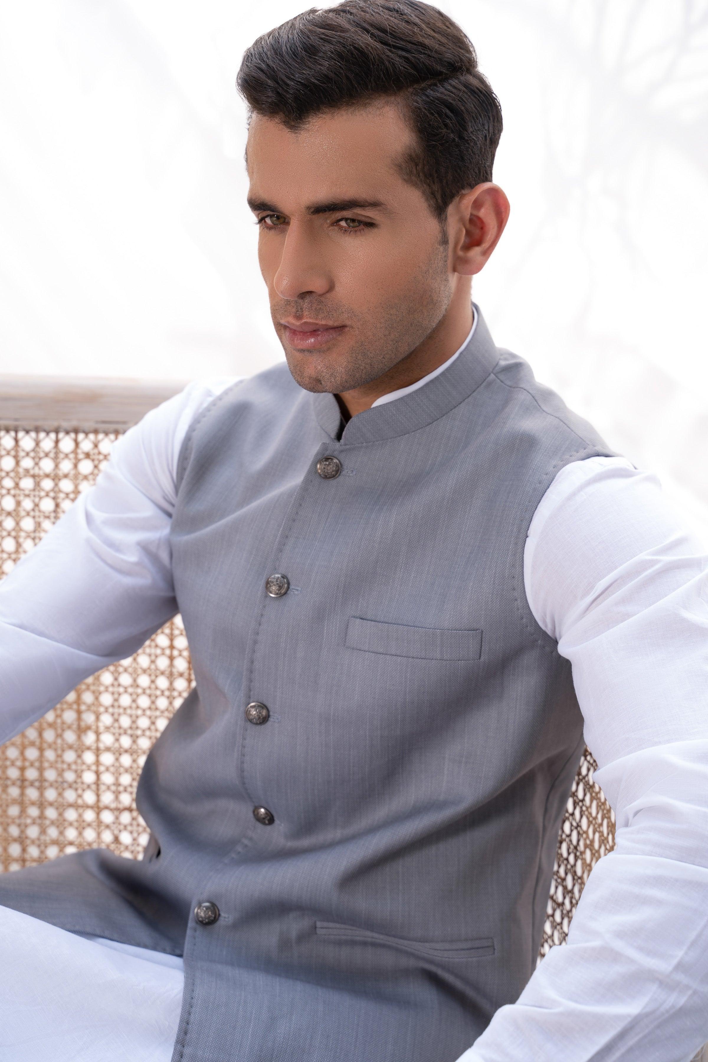 Light grey waistcoat close-up with stand collar, metal buttons, and chest pocket