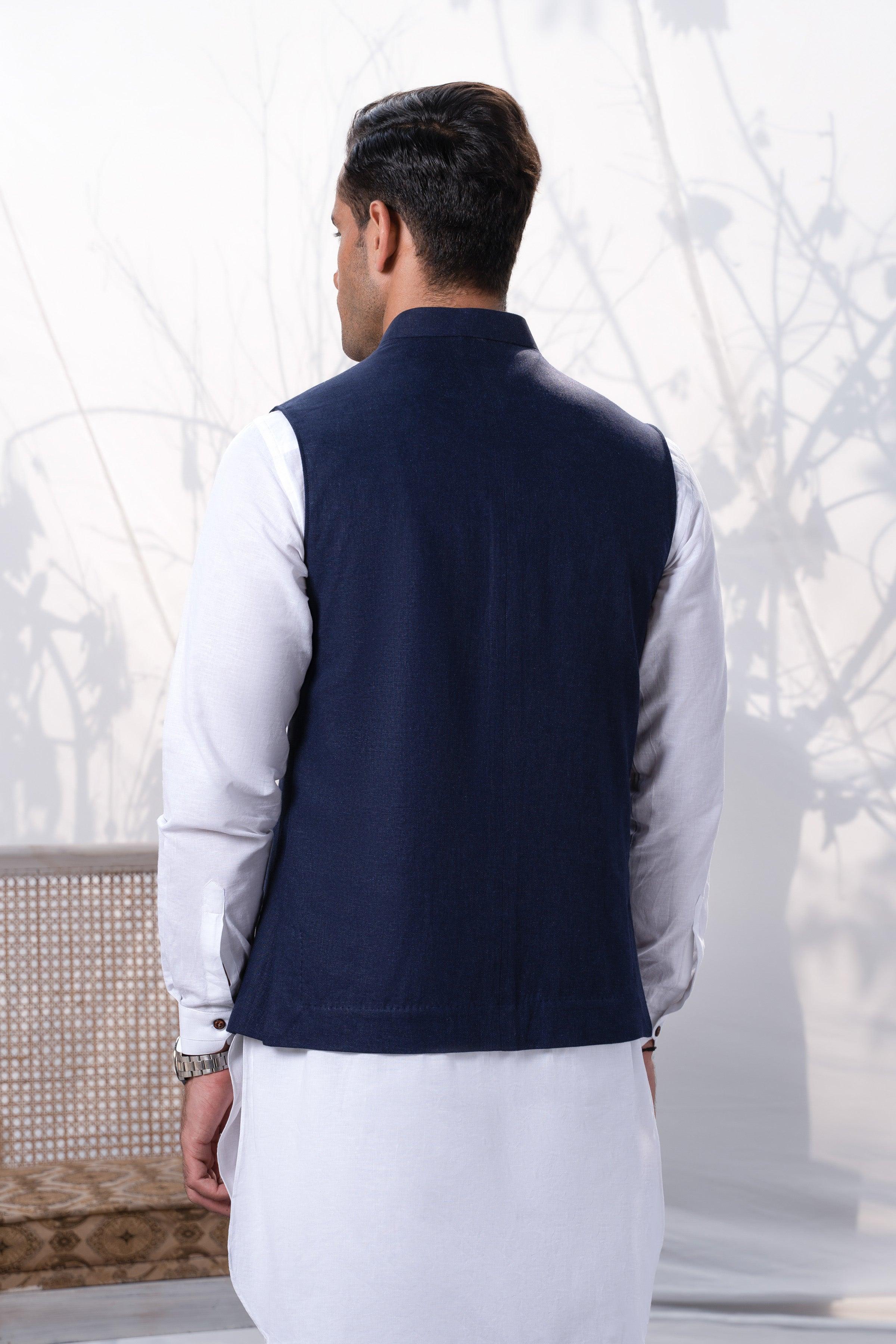 Back view of a navy waistcoat with button front, worn over a white shirt