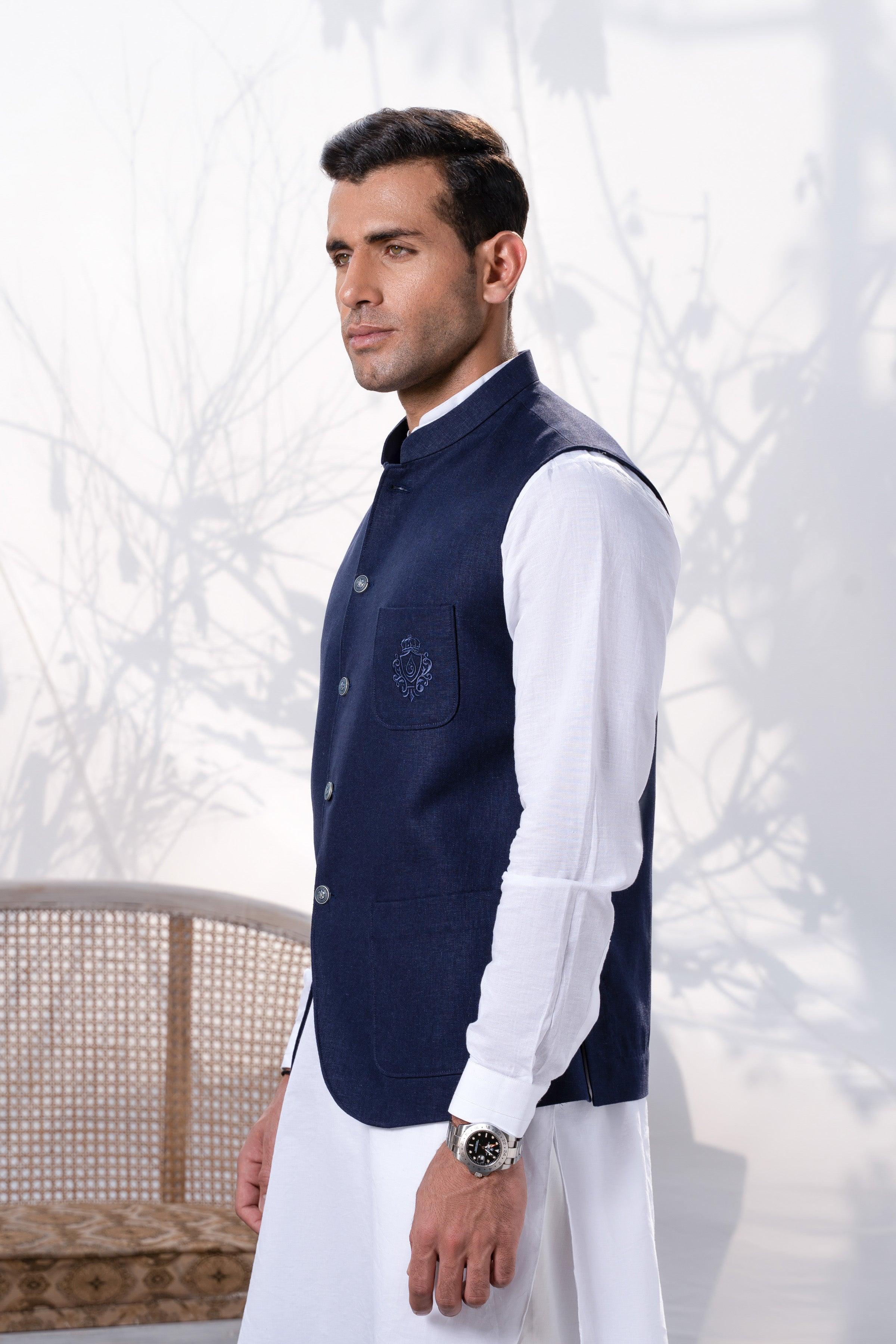 Navy waistcoat with button front and chest emblem, worn over a white shirt