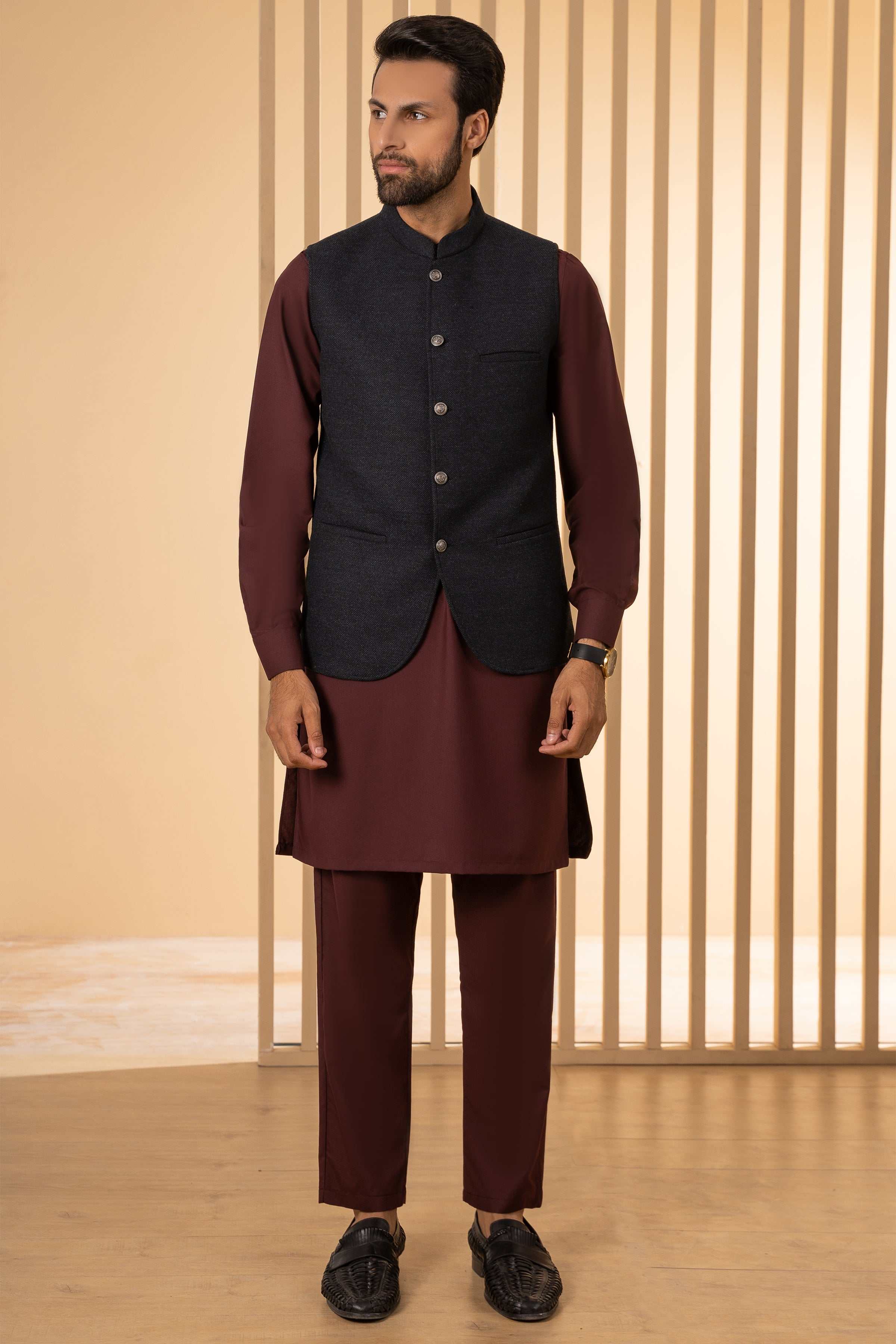 Navy waistcoat with front button placket and side pockets, worn with trousers