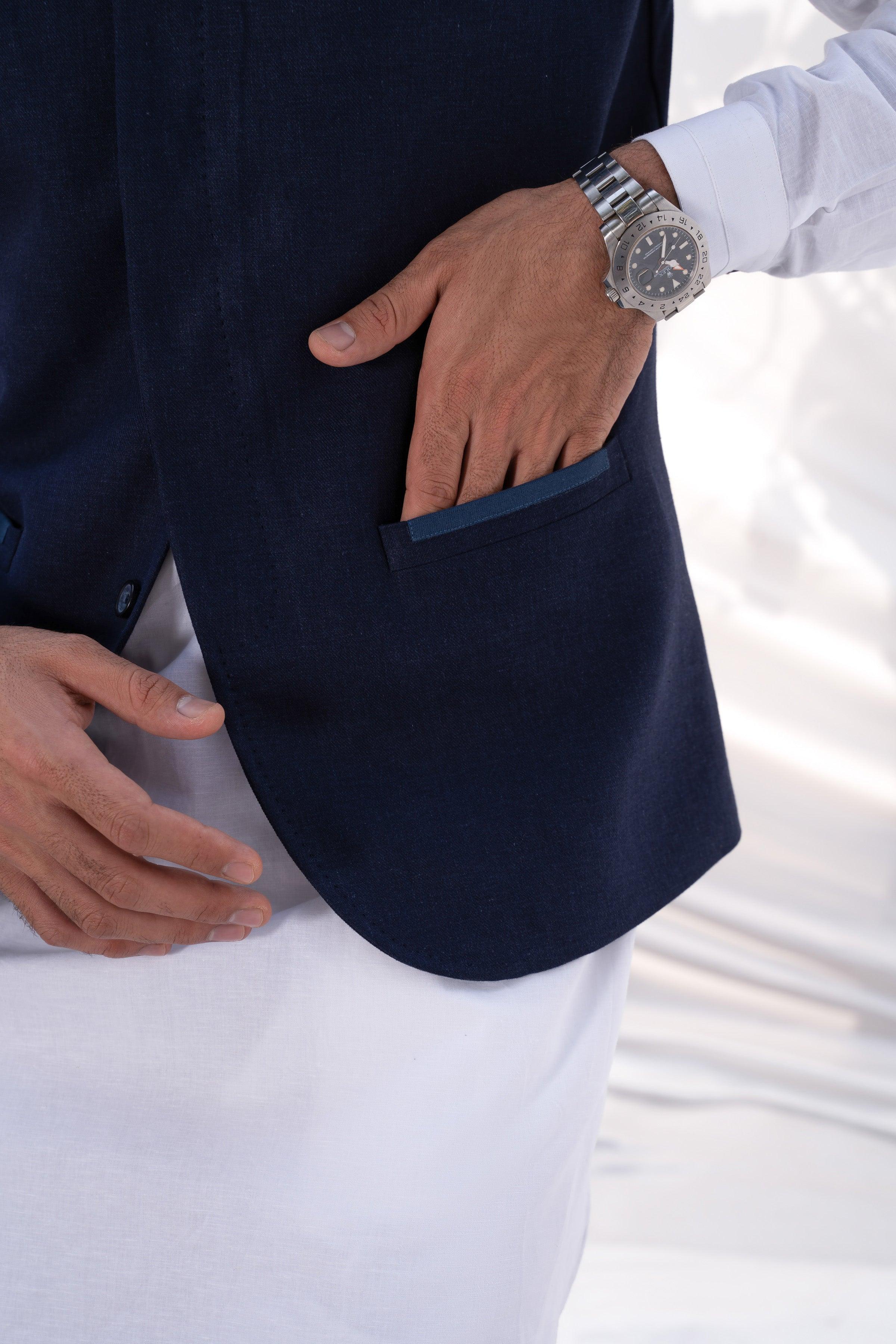Navy waistcoat detail with side welt pocket and textured fabric close-up