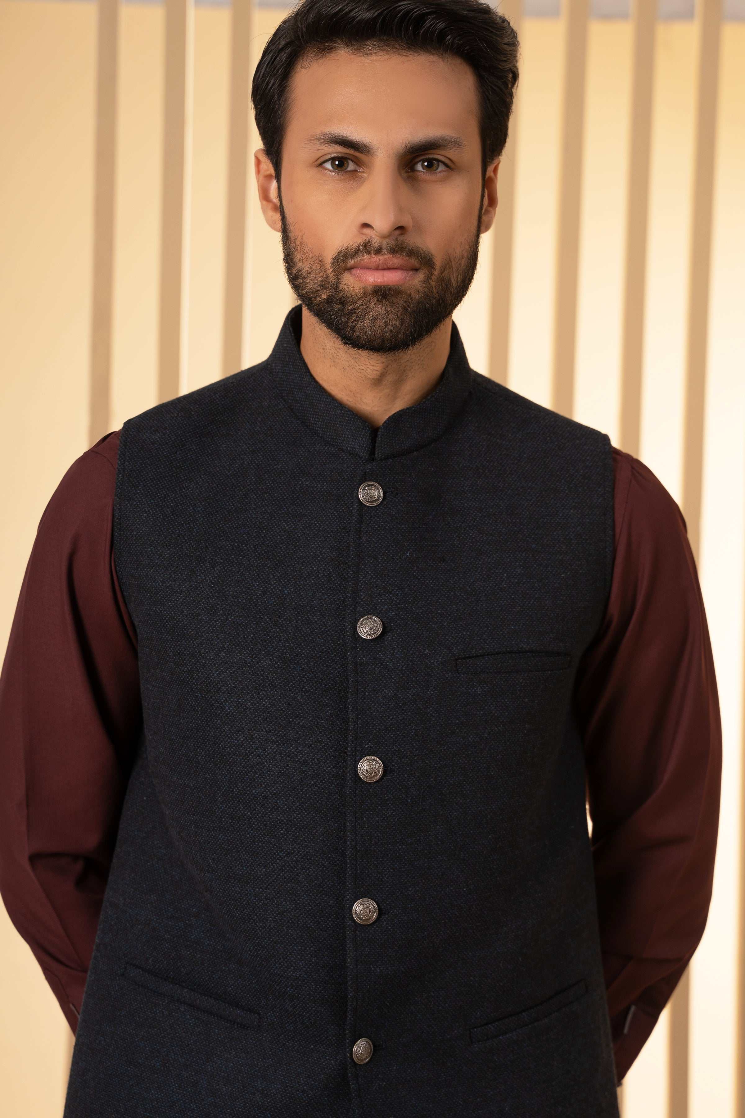 Navy waistcoat with stand collar, round buttons, and chest welt pocket
