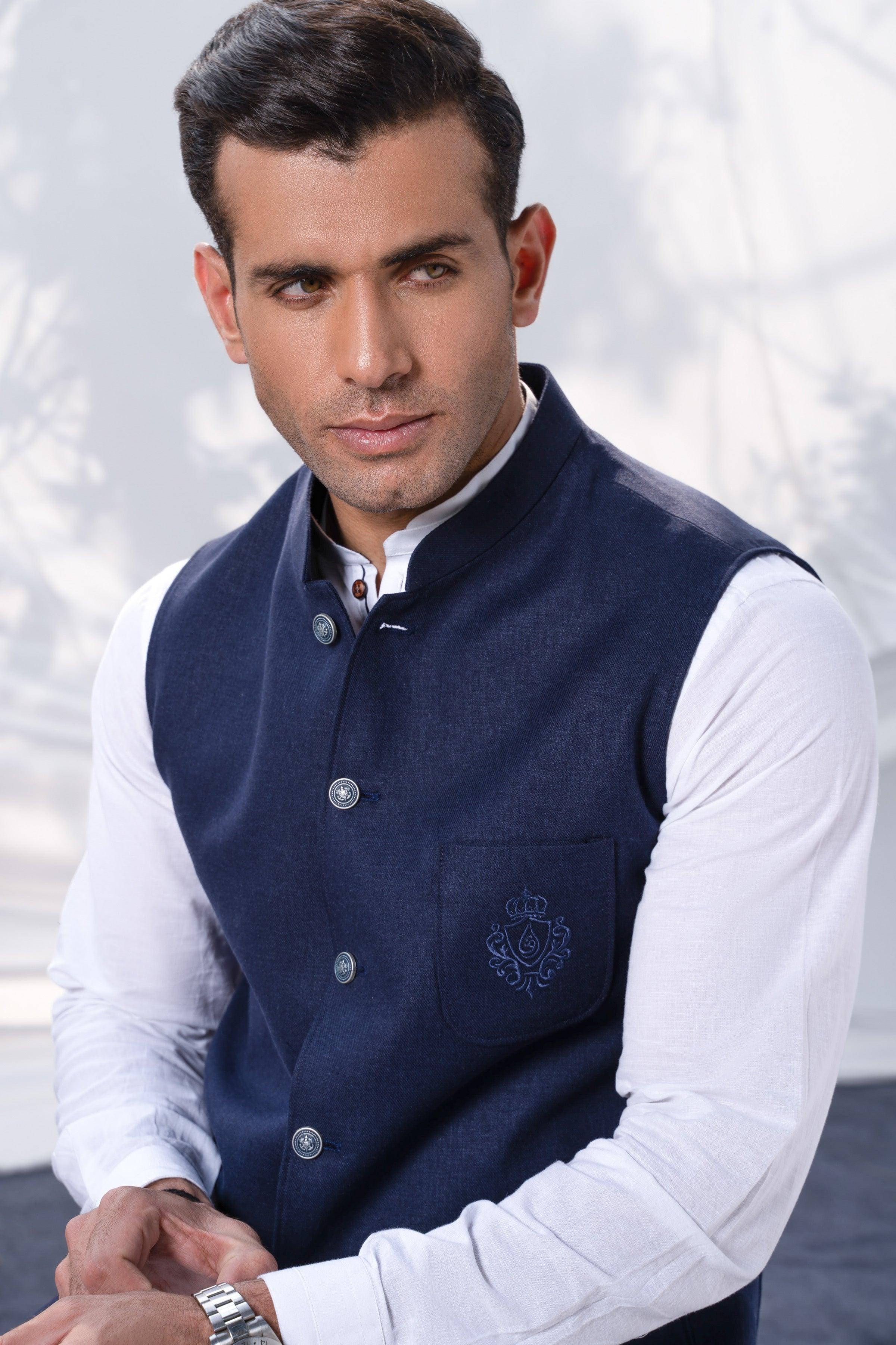 Navy waistcoat with button placket and chest emblem, worn over a white shirt