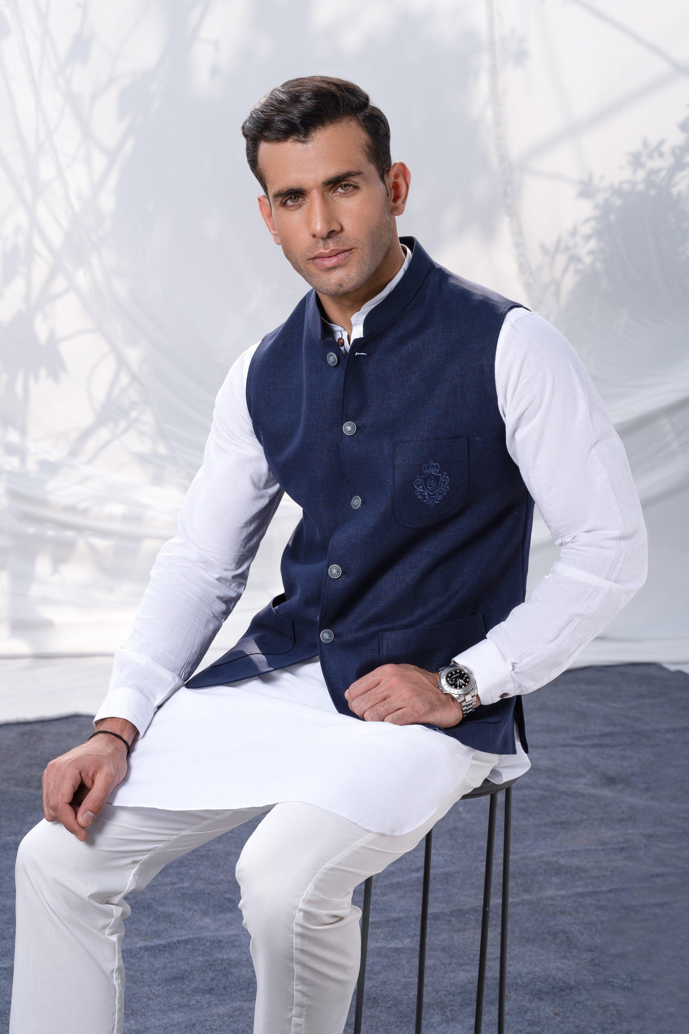 Navy waistcoat with button front and side pockets, worn over a white shirt