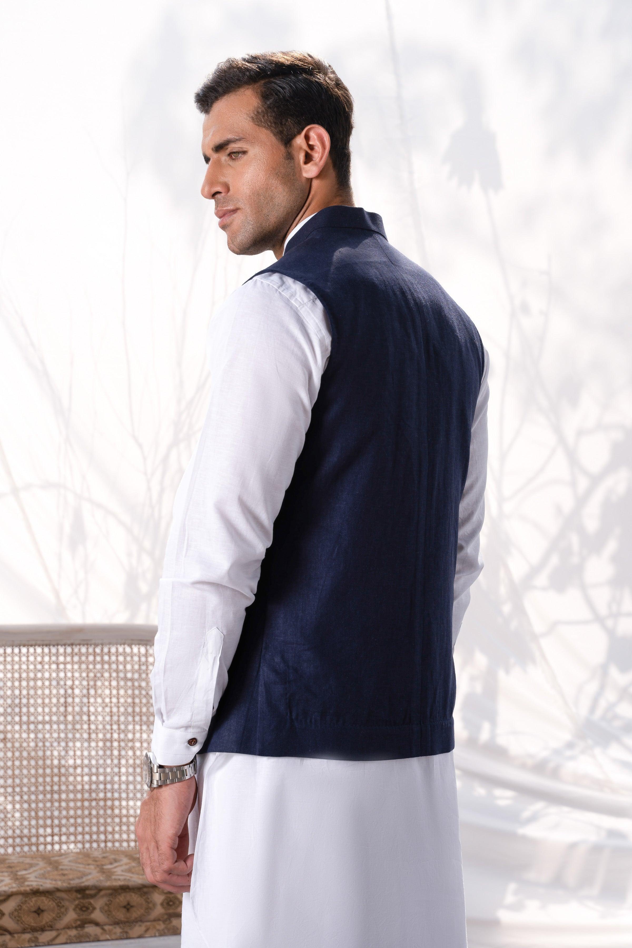 Navy waistcoat side view with smooth back, worn over a white dress shirt