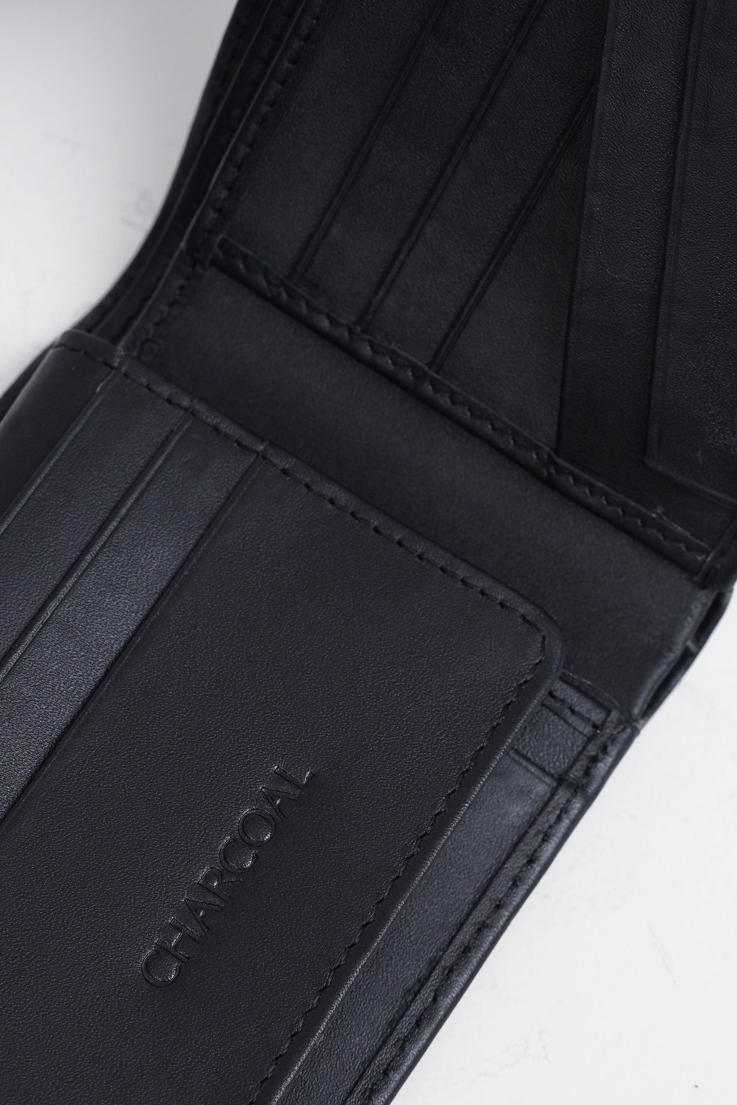 Black wallet card holder panel with embossed logo near edge