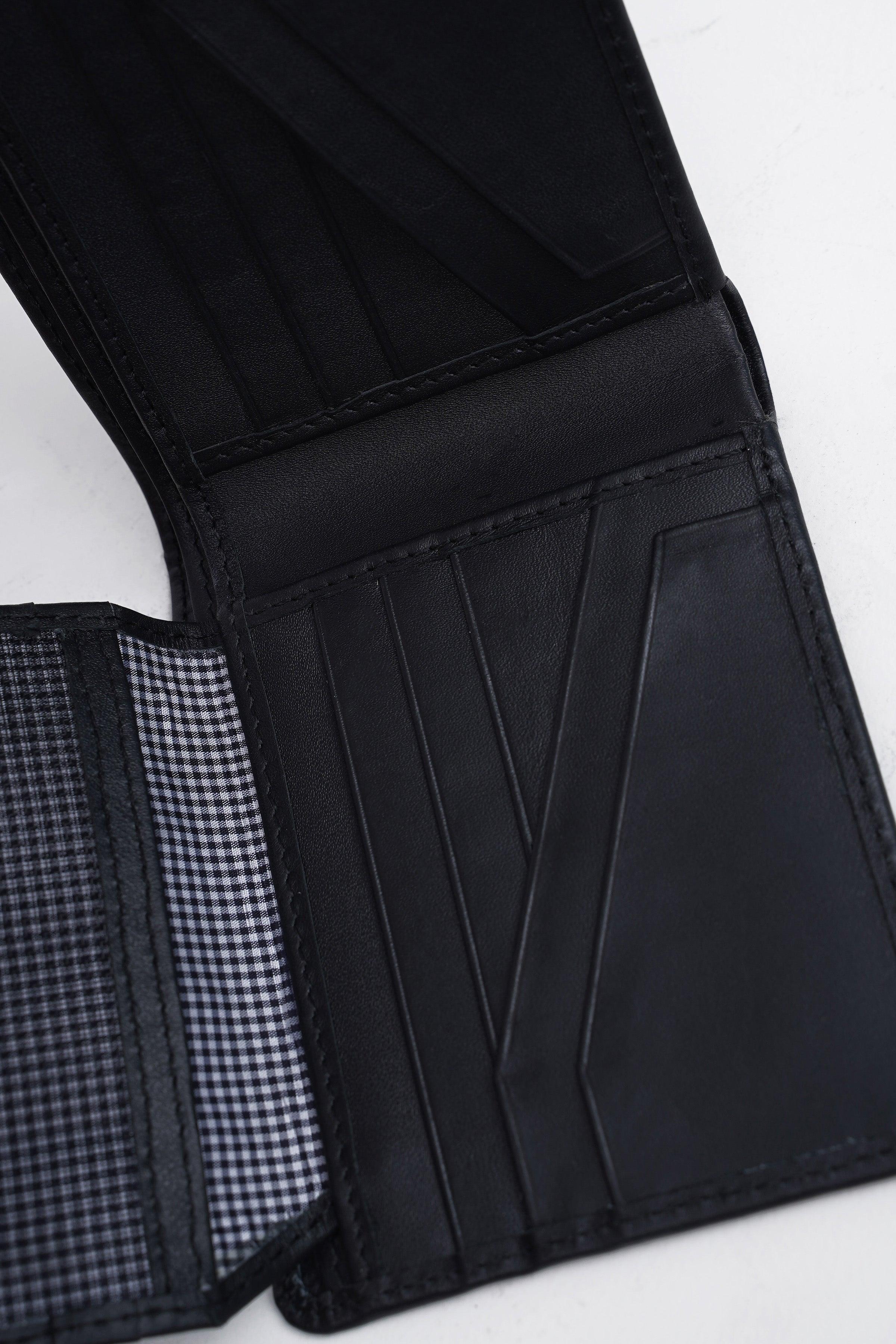 Black wallet interior with card slots and black-and-white check lining