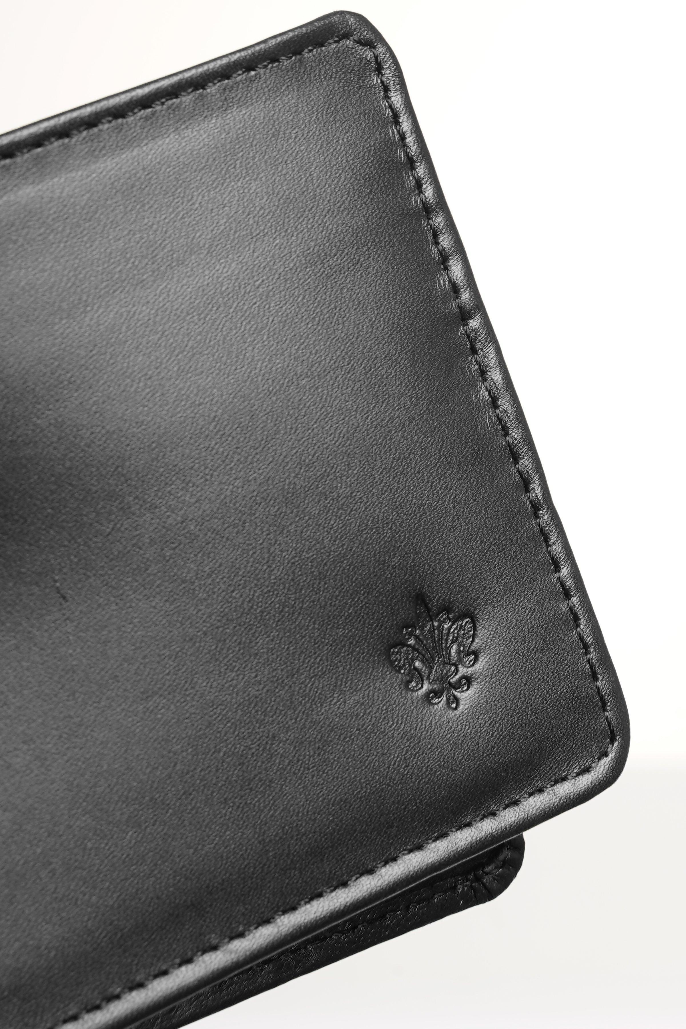 Black leather wallet corner with embossed crest and stitched border