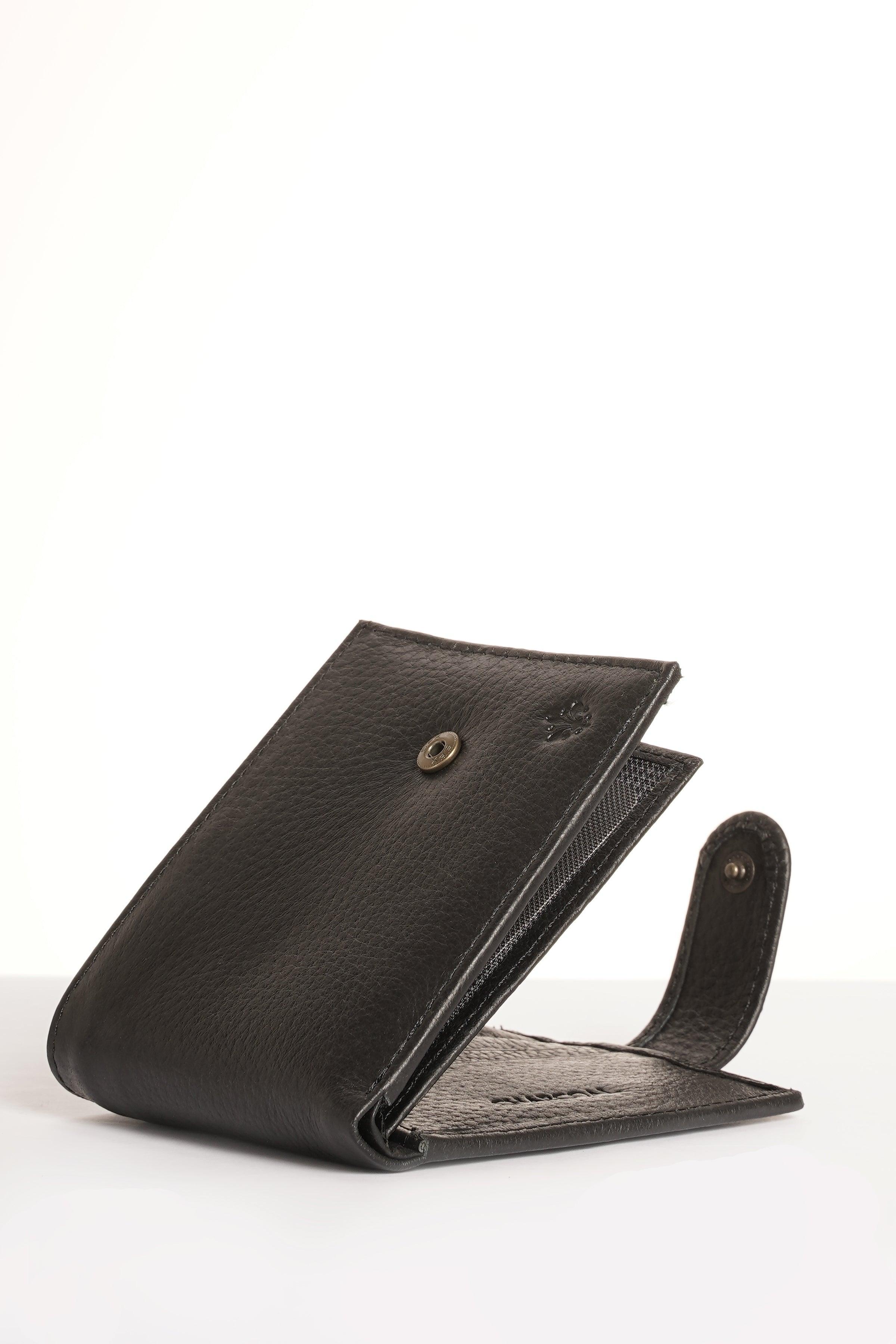 Black leather bifold wallet, side view with snap clasp