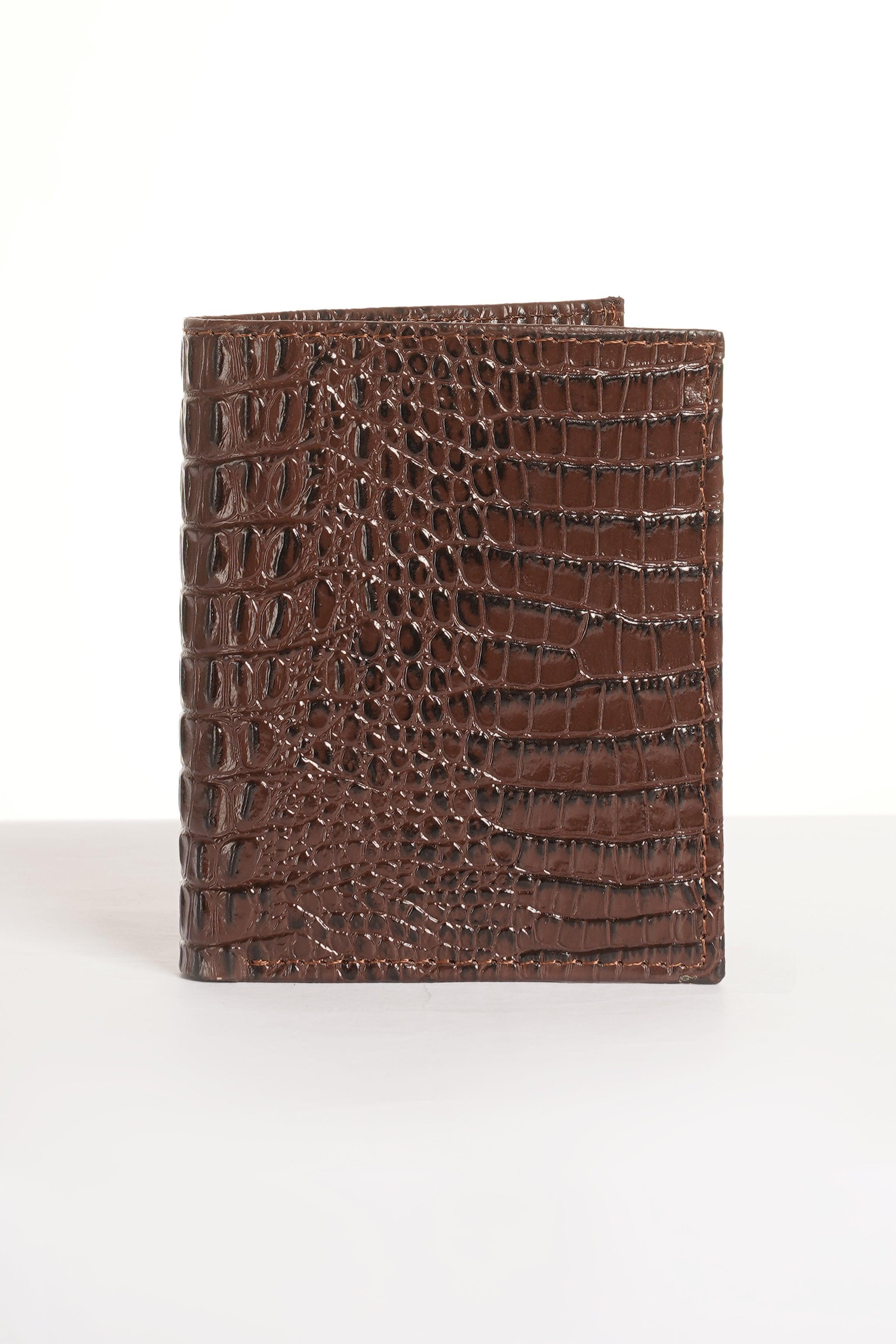 Brown croc-textured leather wallet with snap closure, front view