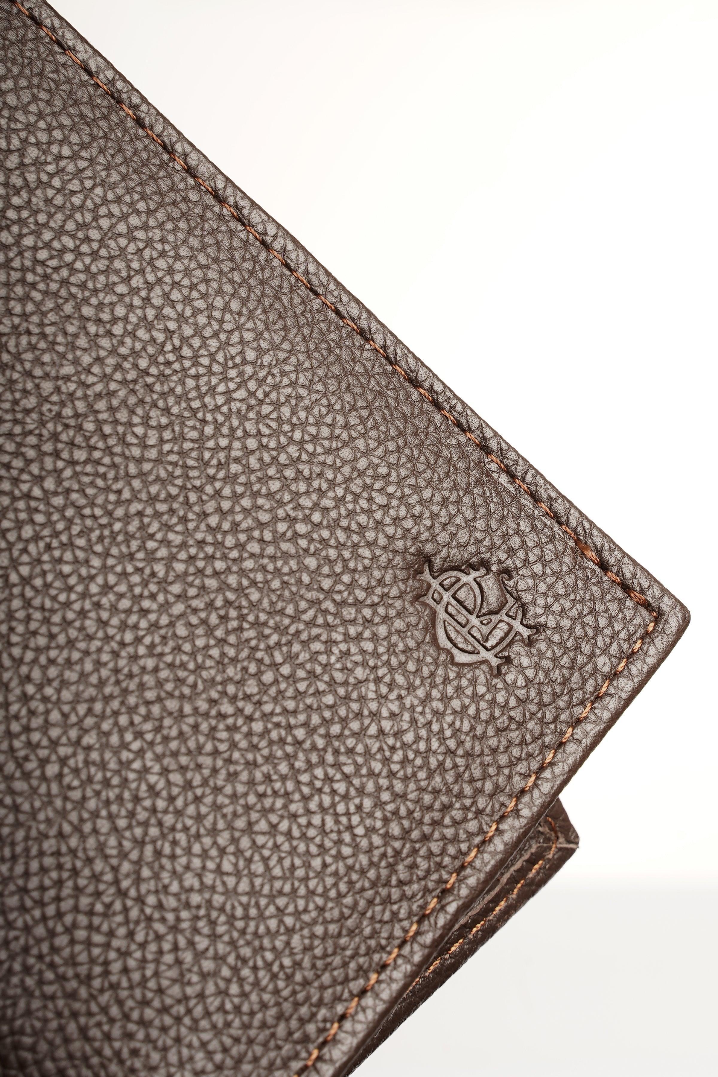 Brown leather wallet corner with embossed logo