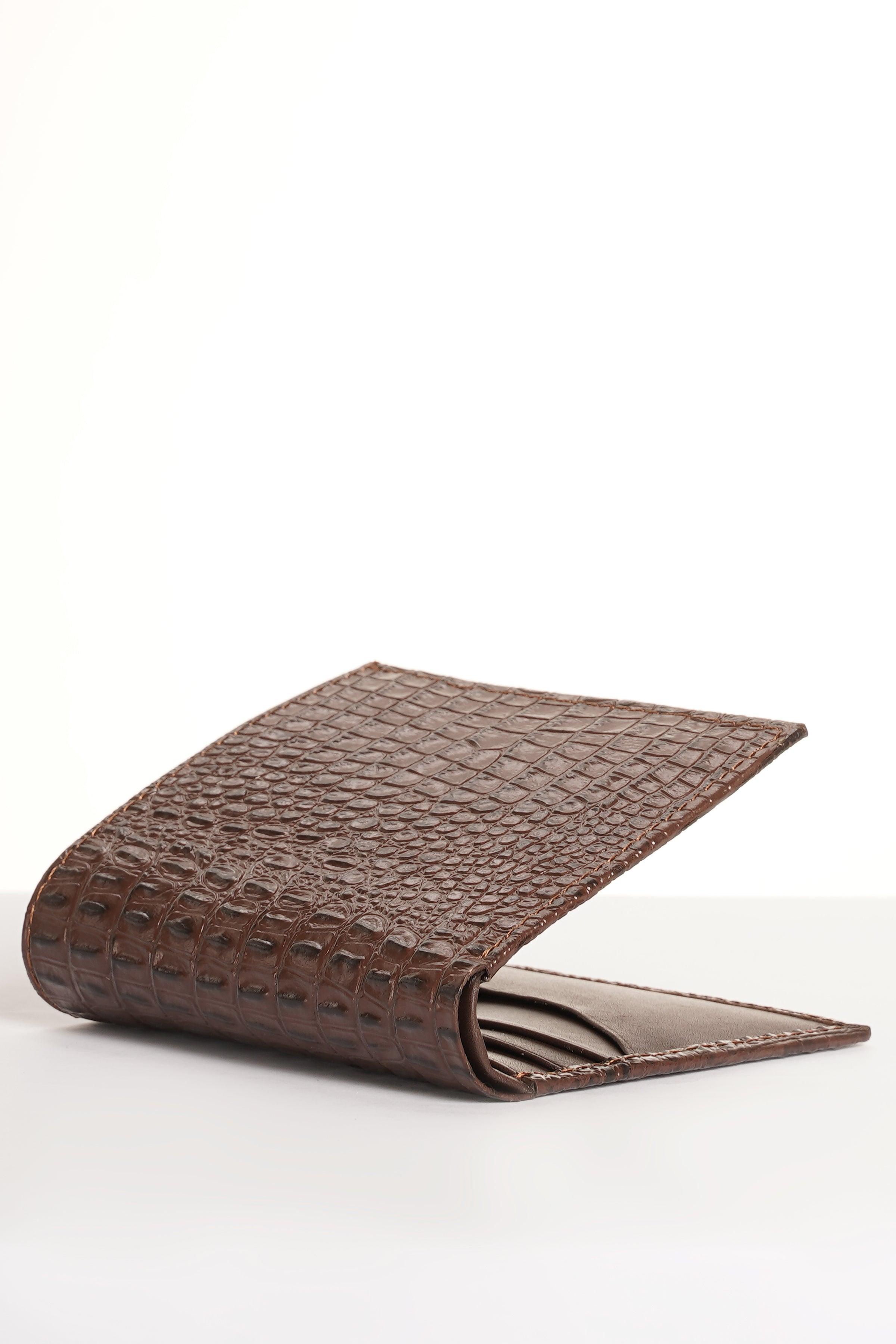 Brown croc-textured leather wallet open, showing card slots