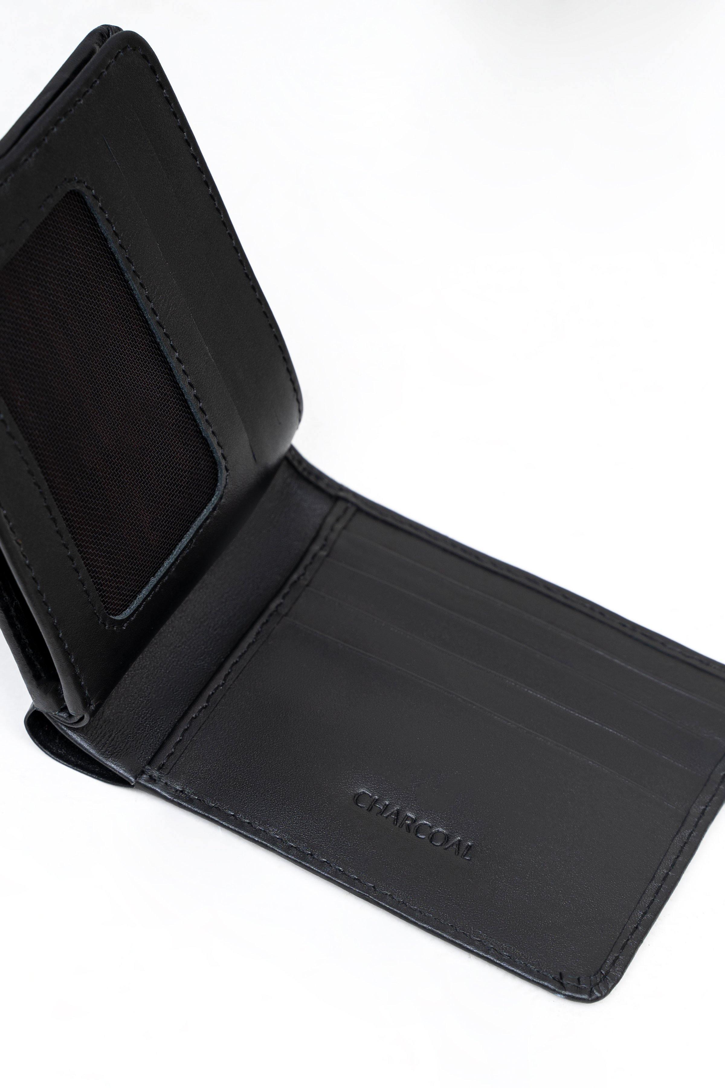 Black bifold wallet interior close-up with card sleeves and stitched panel